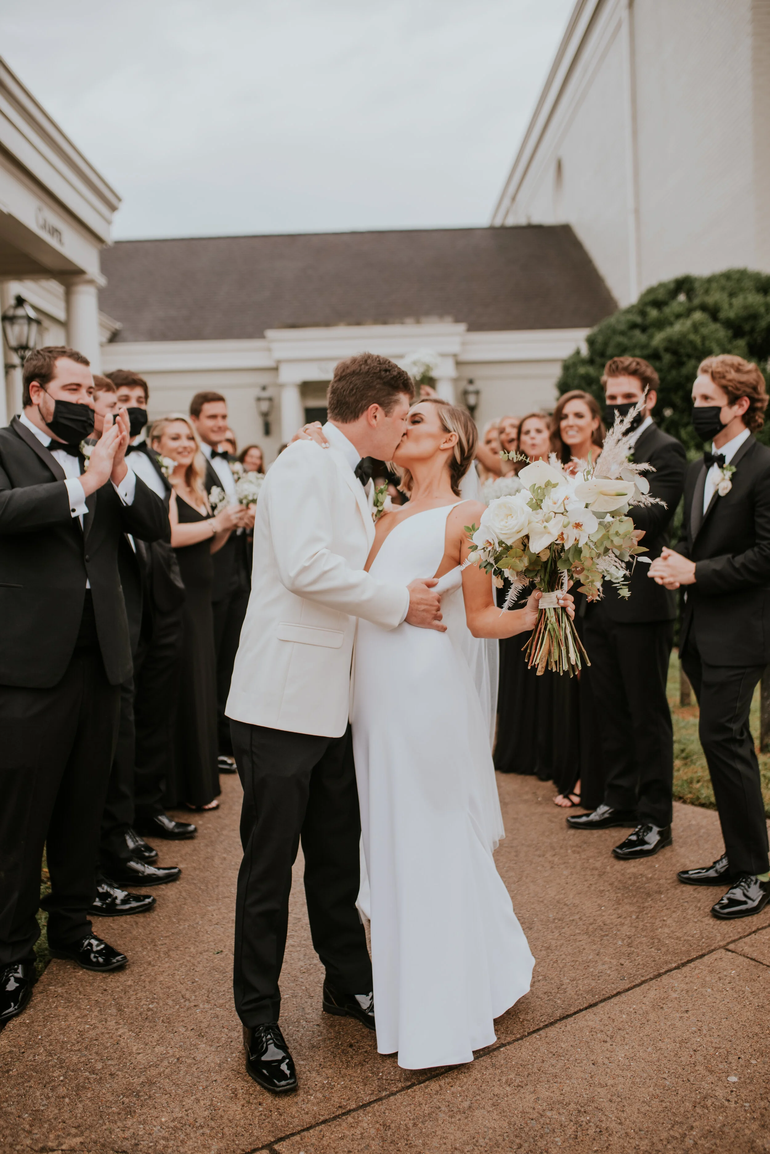 Bohemian and modern yet classically elegant. This Bridal bouquet perfectly married boho elements of pampas grass, eucalyptus, and dried florals with topical stems of anthurium, orchid and ranunculus for a fresh take on white. Designed by Nashville w…