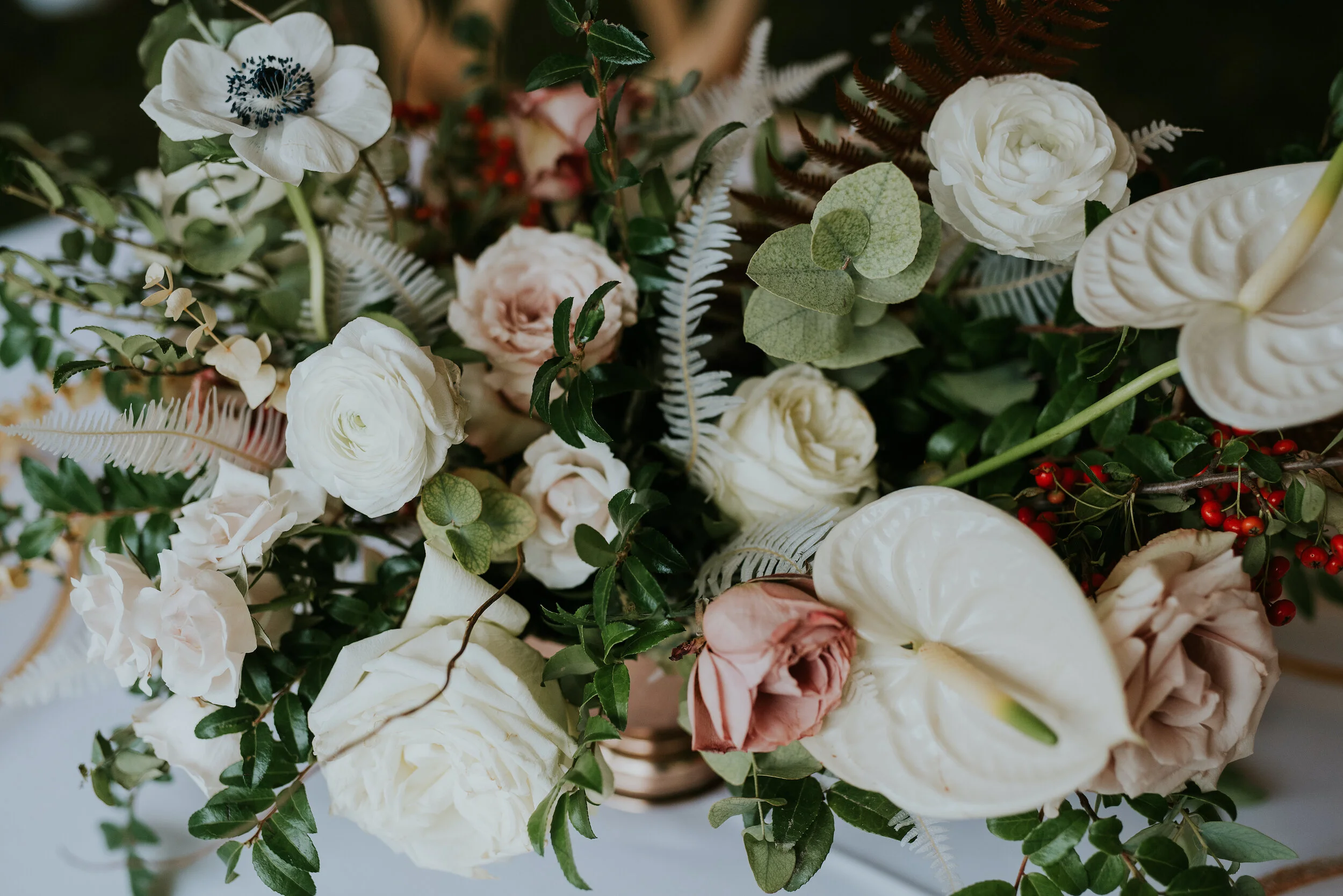 Bohemian and modern yet classically elegant. This wedding perfectly married boho elements of pampas grass, eucalyptus, and dried florals with topical stems of anthurium and orchid. Quicksand roses, cappuccino roses, ilex berry, and rust fern add a p…