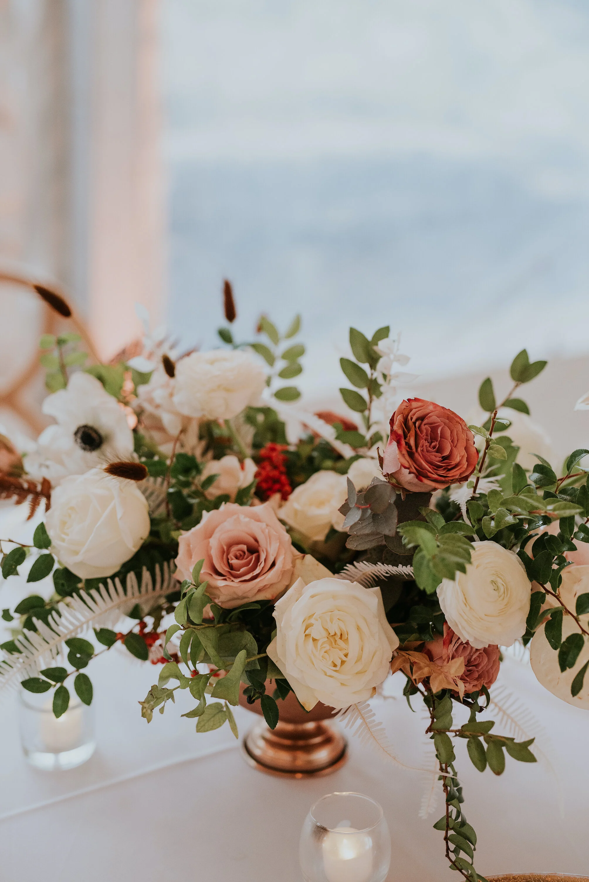 Bohemian and modern yet classically elegant. This wedding perfectly married boho elements of pampas grass, eucalyptus, and dried florals with topical stems of anthurium and orchid. Quicksand roses, cappuccino roses, ilex berry, and rust fern add a p…