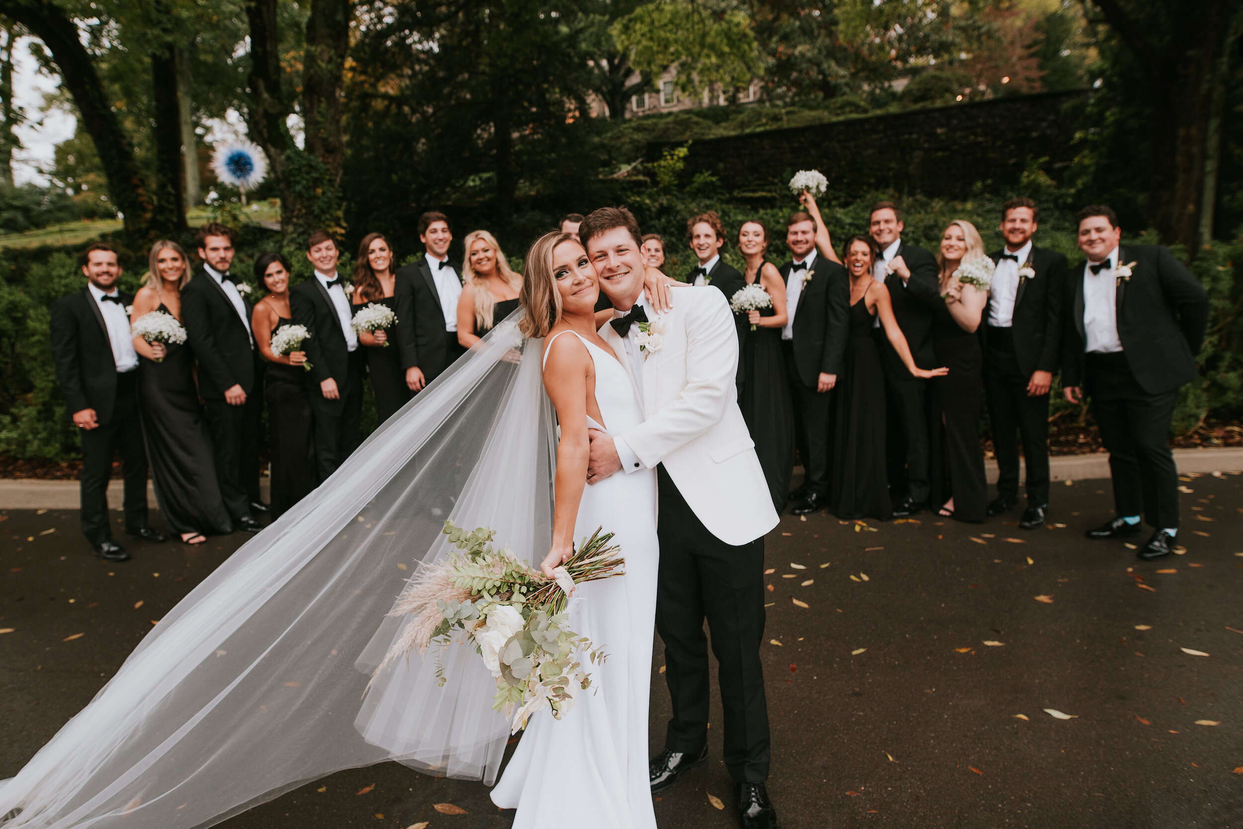 Bohemian and modern yet classically elegant. This Bridal bouquet perfectly married boho elements of pampas grass, eucalyptus, and dried florals with topical stems of anthurium, orchid and ranunculus for a fresh take on white. Paired with simple brid…