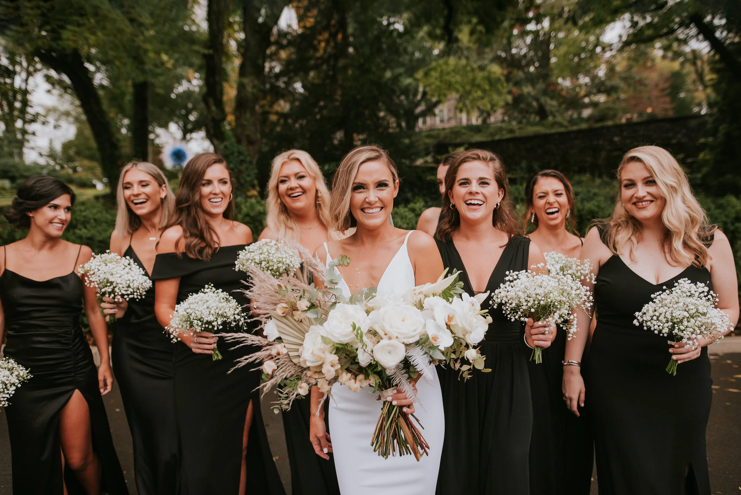 Bohemian and modern yet classically elegant. This Bridal bouquet perfectly married boho elements of pampas grass, eucalyptus, and dried florals with topical stems of anthurium, orchid and ranunculus for a fresh take on white. Paired with simple brid…