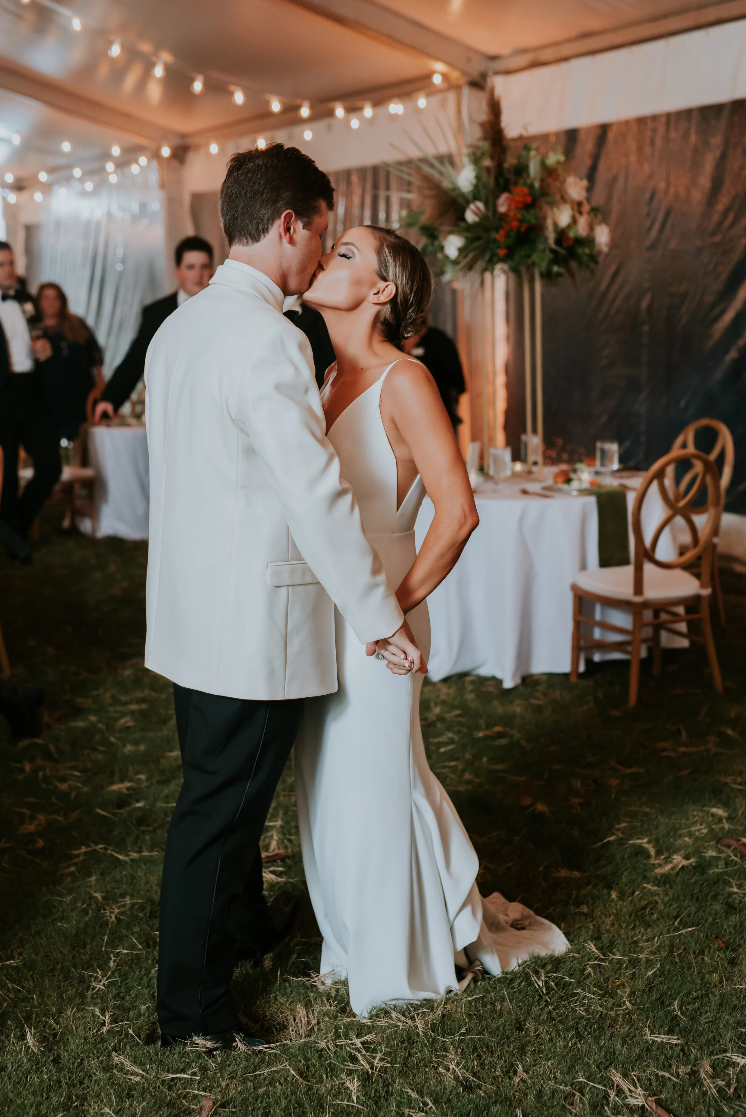 Bohemian and modern yet classically elegant. This wedding perfectly married boho elements of pampas grass, eucalyptus, and dried florals with topical stems of anthurium and orchid. Quicksand roses, cappuccino roses, ilex berry, and rust fern add a p…