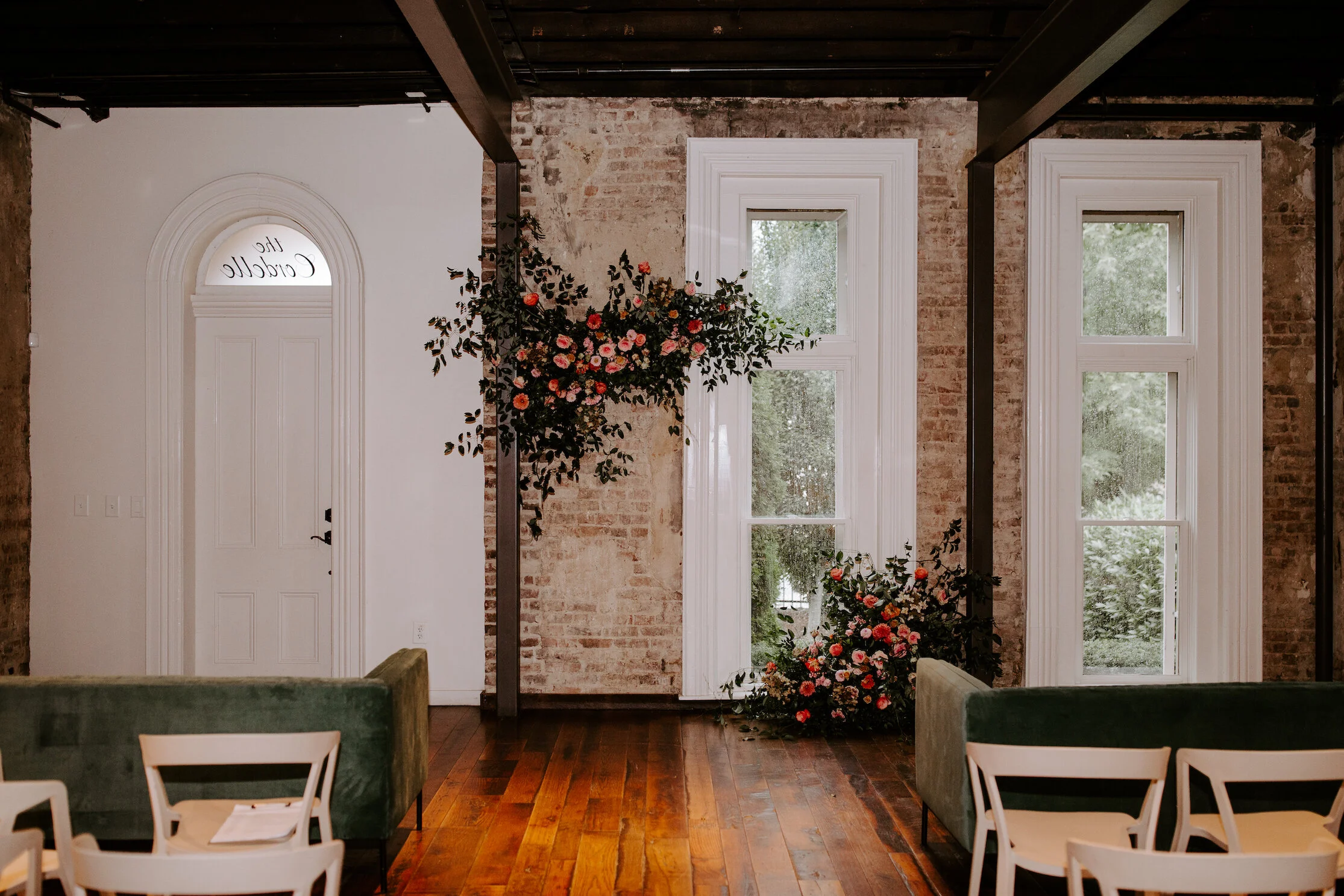 This wedding featured a stunning ceremony arch and a moss and floral wall installation. Blooms used were coral zinnias, fuchsia and blush dahlias, tangerine ranunculus, petal-heavy roses, pink snowberry, and sprawling smilax vine. Designed by Nashvi…