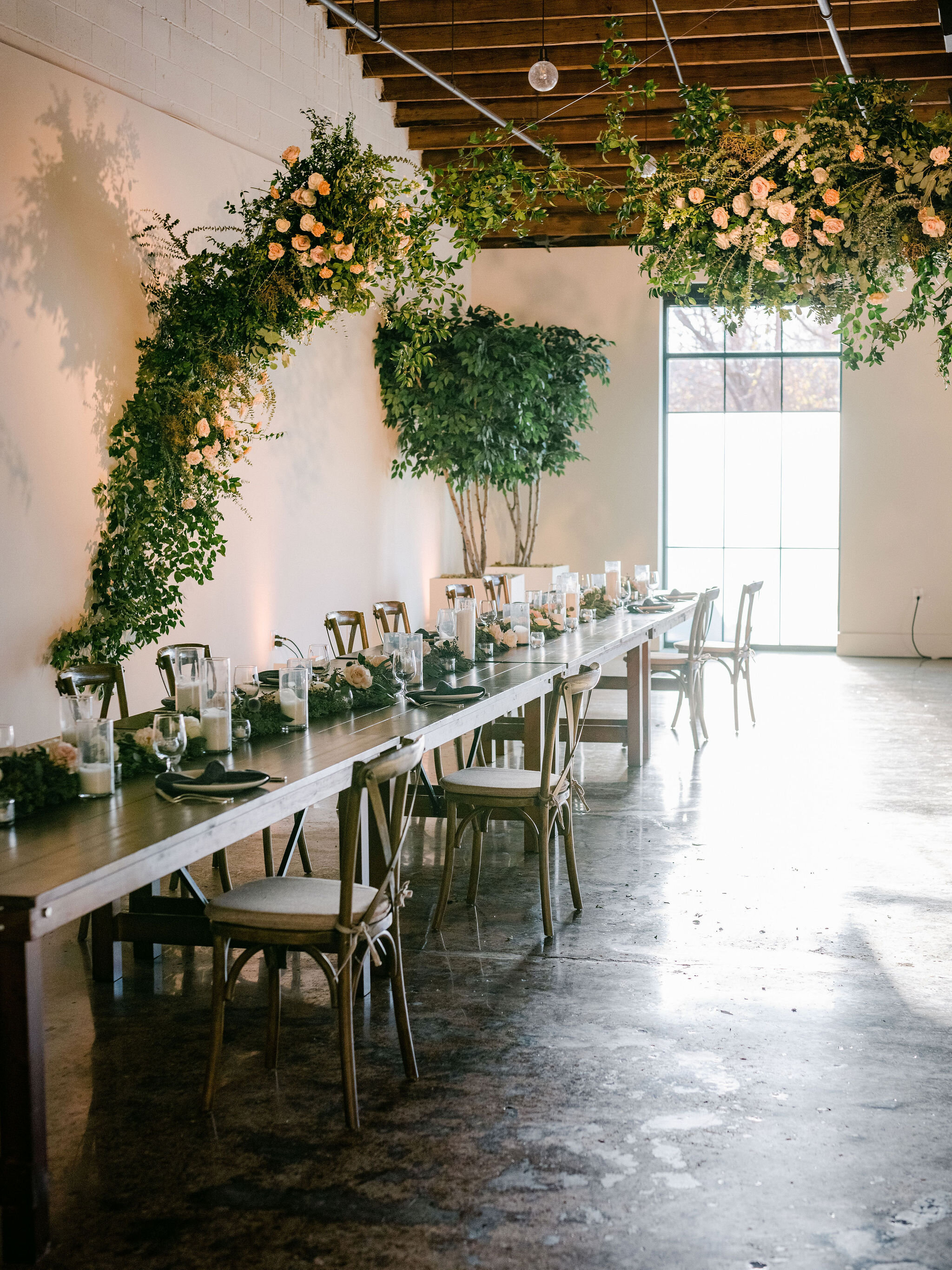 A dramatic and winding installation full of movement that grew up the back wall, across the head table and out into the dance floor. Filled with white and blush garden roses, spray roses, delphinium, blue thistle, heirloom carnations, eucalyptus and…