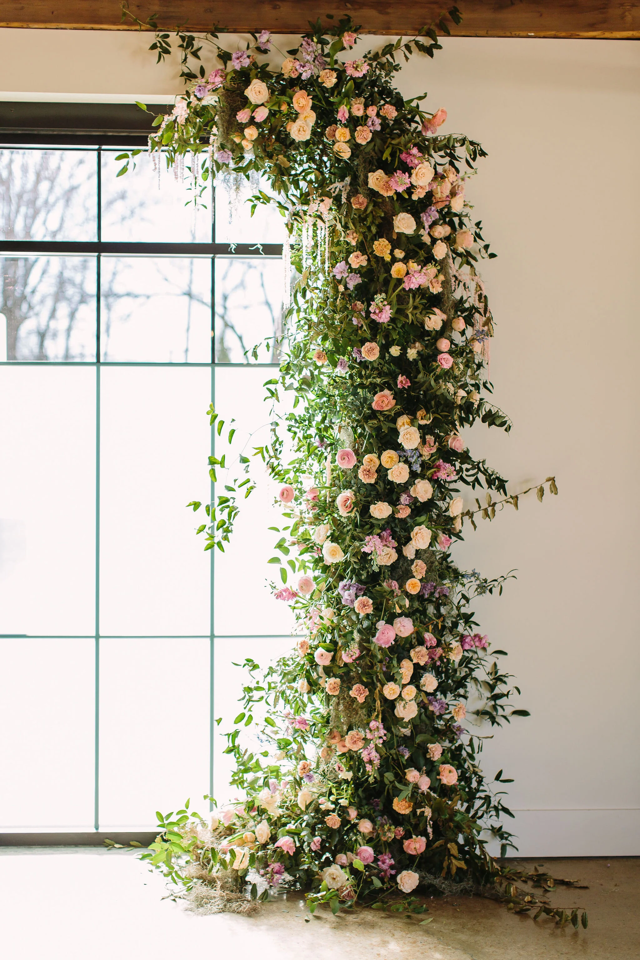 An intimate installation intensive at The Saint Elle in Nashville. Students learned how to create and build 3 different kinds of installations. This climbing window install is filled with flowers in pastel hues including petal heavy roses, lavender …