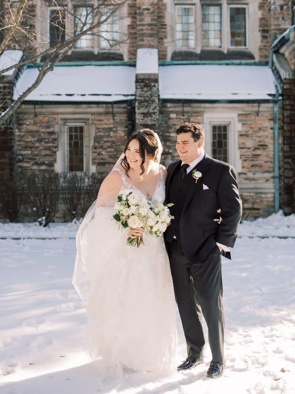 This wintery bridal bouquet is filled with white ice roses, fluffy ranunculus, draping pieris, majolica spray roses, white sweet pea, ivory lisianthus, and patience garden rose. Designed by florist Rosemary & Finch in Nashville, TN.