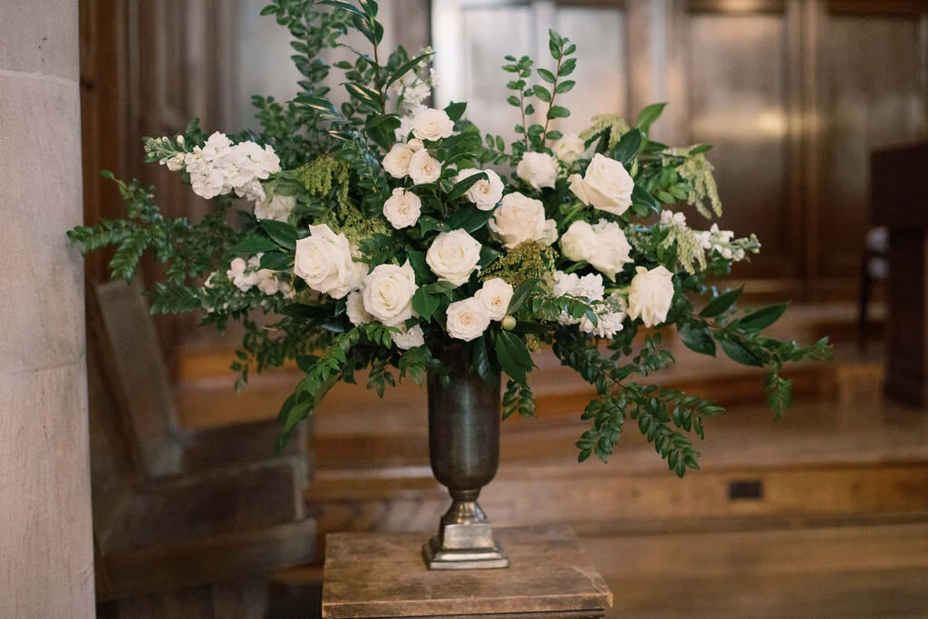 This wintery white wedding at The Cordelle is filled with neutral details, romantic blooms, and several unique installations. Featured here is a lush arrangement of blush quicksand roses, white ice roses, majolica spray roses, and sprawling greenery…