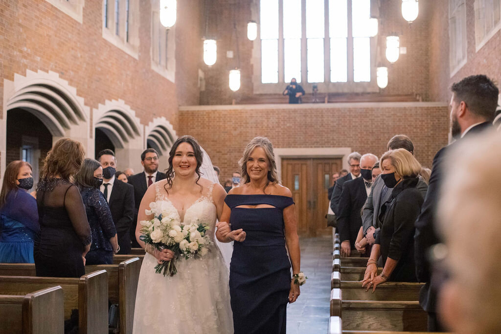 This wintery bridal bouquet is filled with white ice roses, fluffy ranunculus, draping pieris, majolica spray roses, white sweet pea, ivory lisianthus, and patience garden rose. Designed by florist Rosemary & Finch in Nashville, TN.