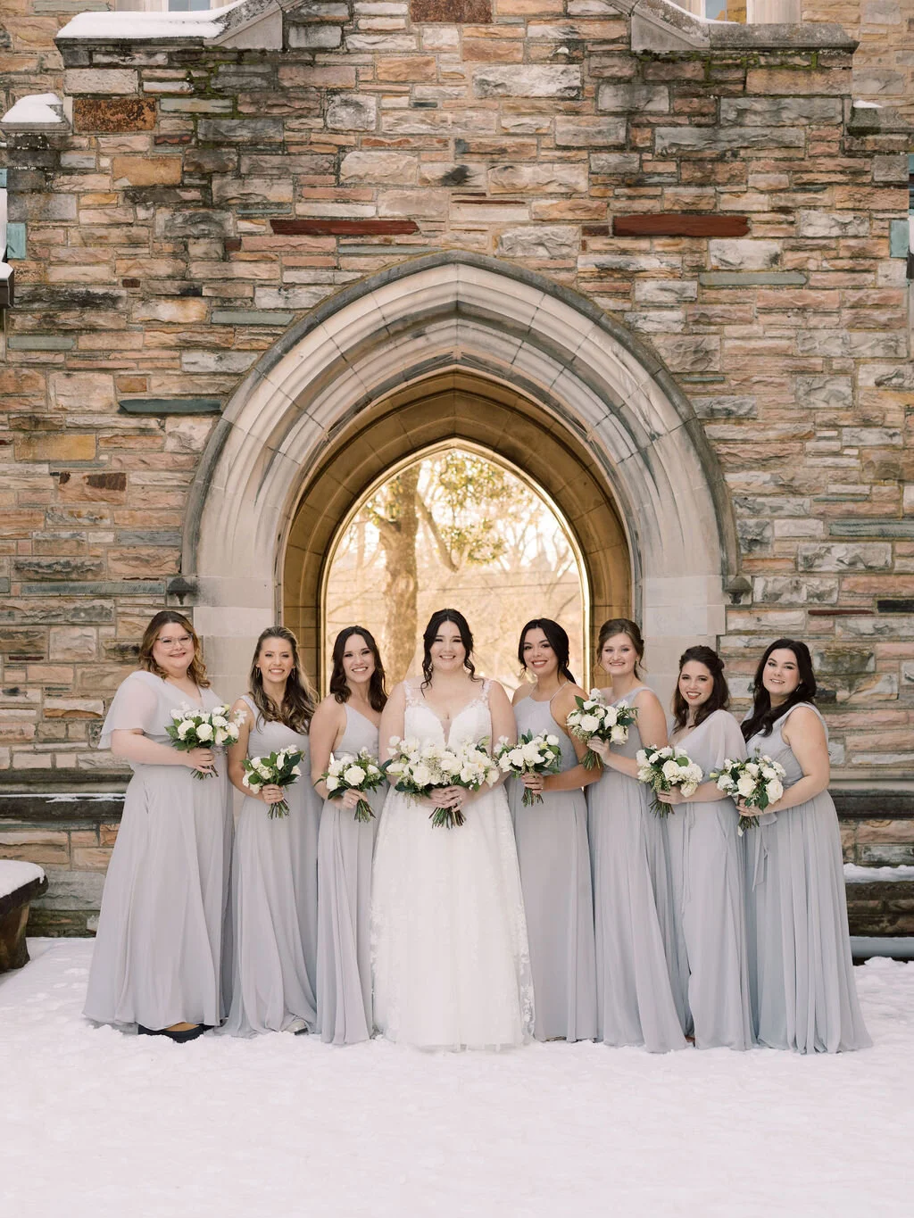 This wintery bridal bouquet is filled with white ice roses, fluffy ranunculus, draping pieris, majolica spray roses, white sweet pea, ivory lisianthus, and patience garden rose. Designed by florist Rosemary & Finch in Nashville, TN.