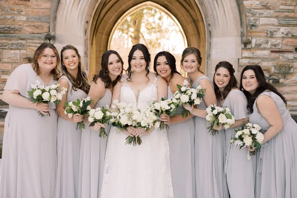 This wintery bridal bouquet is filled with white ice roses, fluffy ranunculus, draping pieris, majolica spray roses, white sweet pea, ivory lisianthus, and patience garden rose. Designed by florist Rosemary & Finch in Nashville, TN.