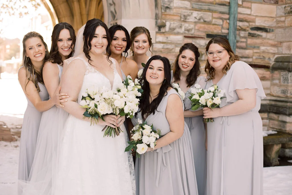 This wintery bridal bouquet is filled with white ice roses, fluffy ranunculus, draping pieris, majolica spray roses, white sweet pea, ivory lisianthus, and patience garden rose. Designed by florist Rosemary & Finch in Nashville, TN.