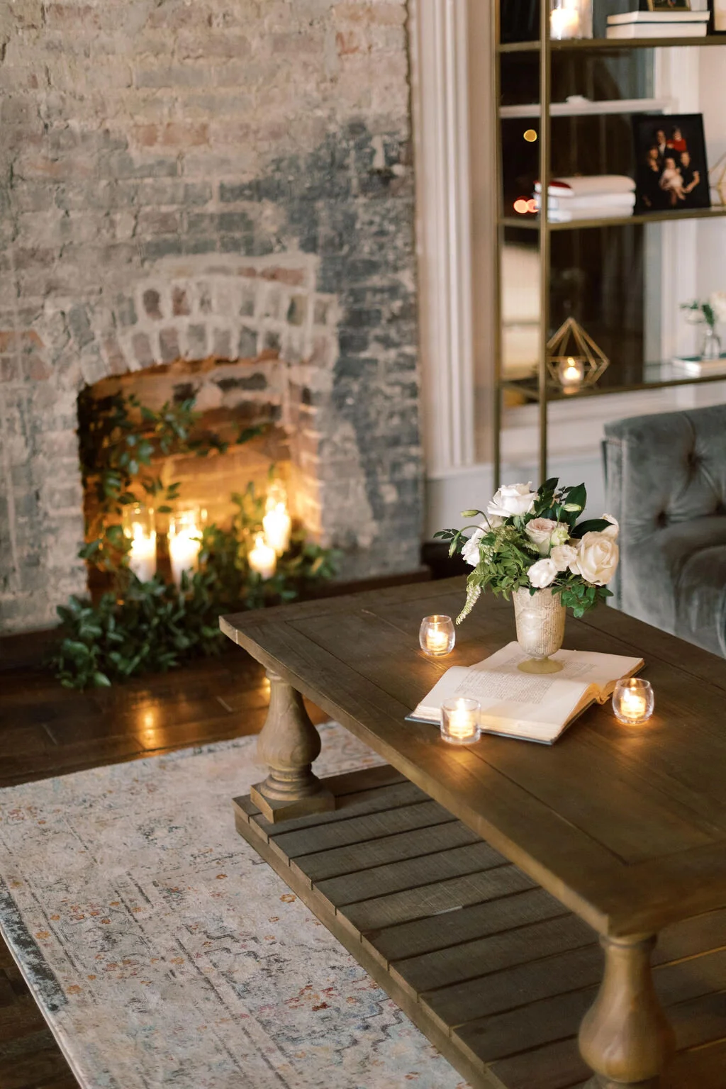 This twinkling reception is filled with taupe tapers in collected brass candlesticks. Centerpieces filled with delicate blooms of quicksand roses, white ice roses, majolica spray roses, fluffy ranunculus, white stock, delicate sweet pea and natural …