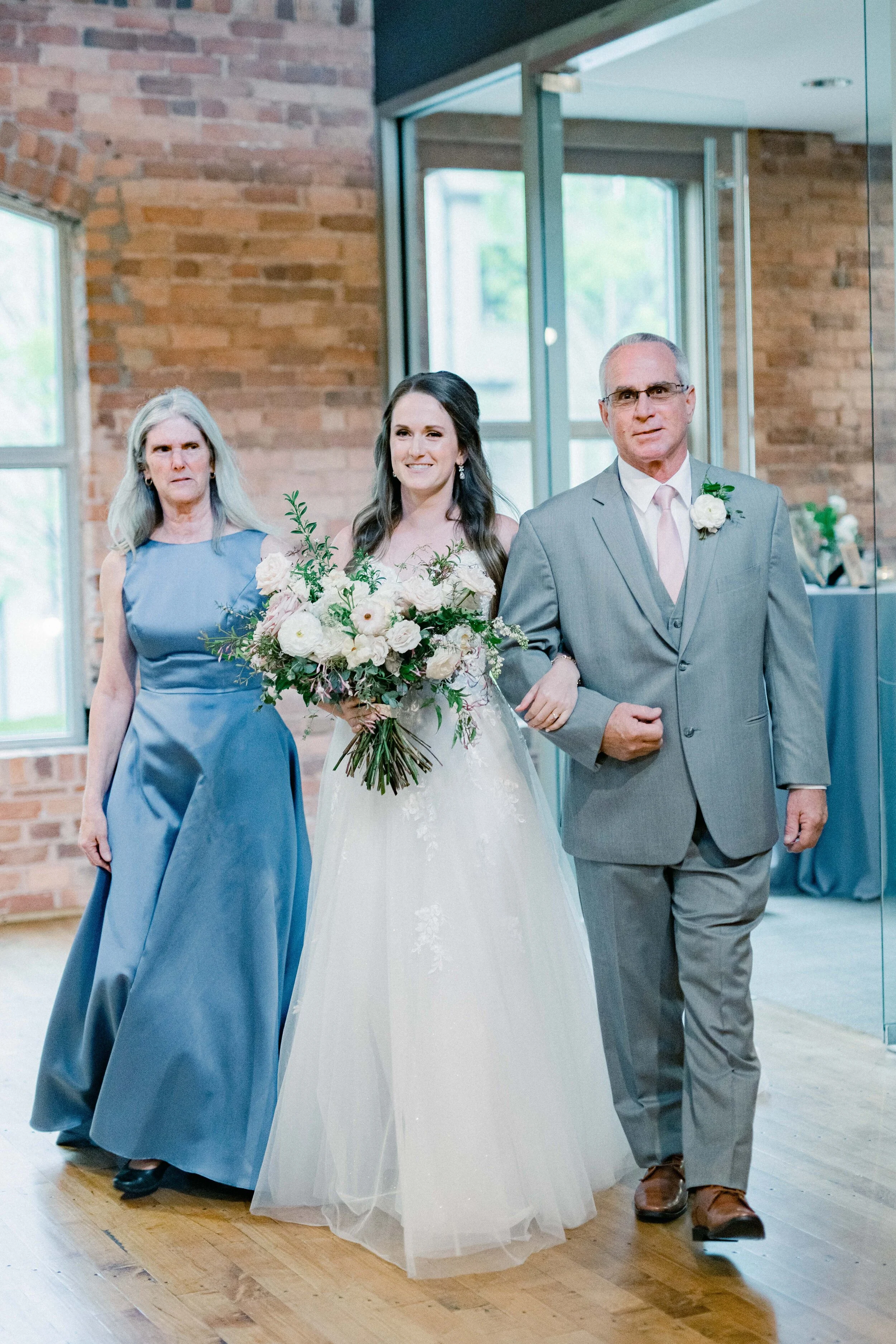 Champagne roses, cream garden roses, trailing jasmine, fluffy ranunculus, quicksand roses, majolica spray roses, and sage eucalyptus make up this gorgeous bridal bouquet. Designed by florist Rosemary & Finch in Nashville, TN.
