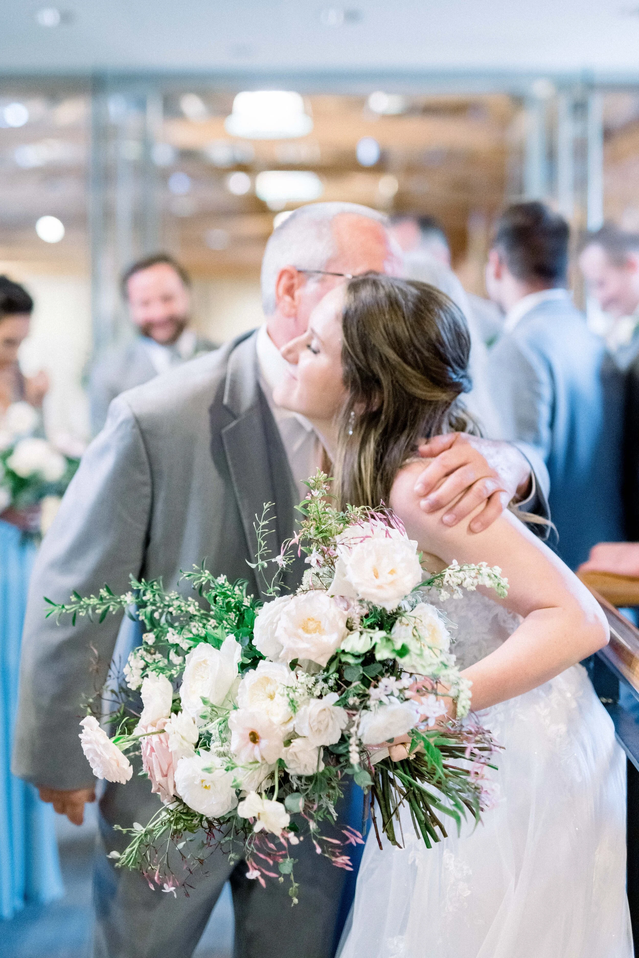 Champagne roses, cream garden roses, trailing jasmine, fluffy ranunculus, quicksand roses, majolica spray roses, and sage eucalyptus make up this gorgeous bridal bouquet. Designed by florist Rosemary & Finch in Nashville, TN.