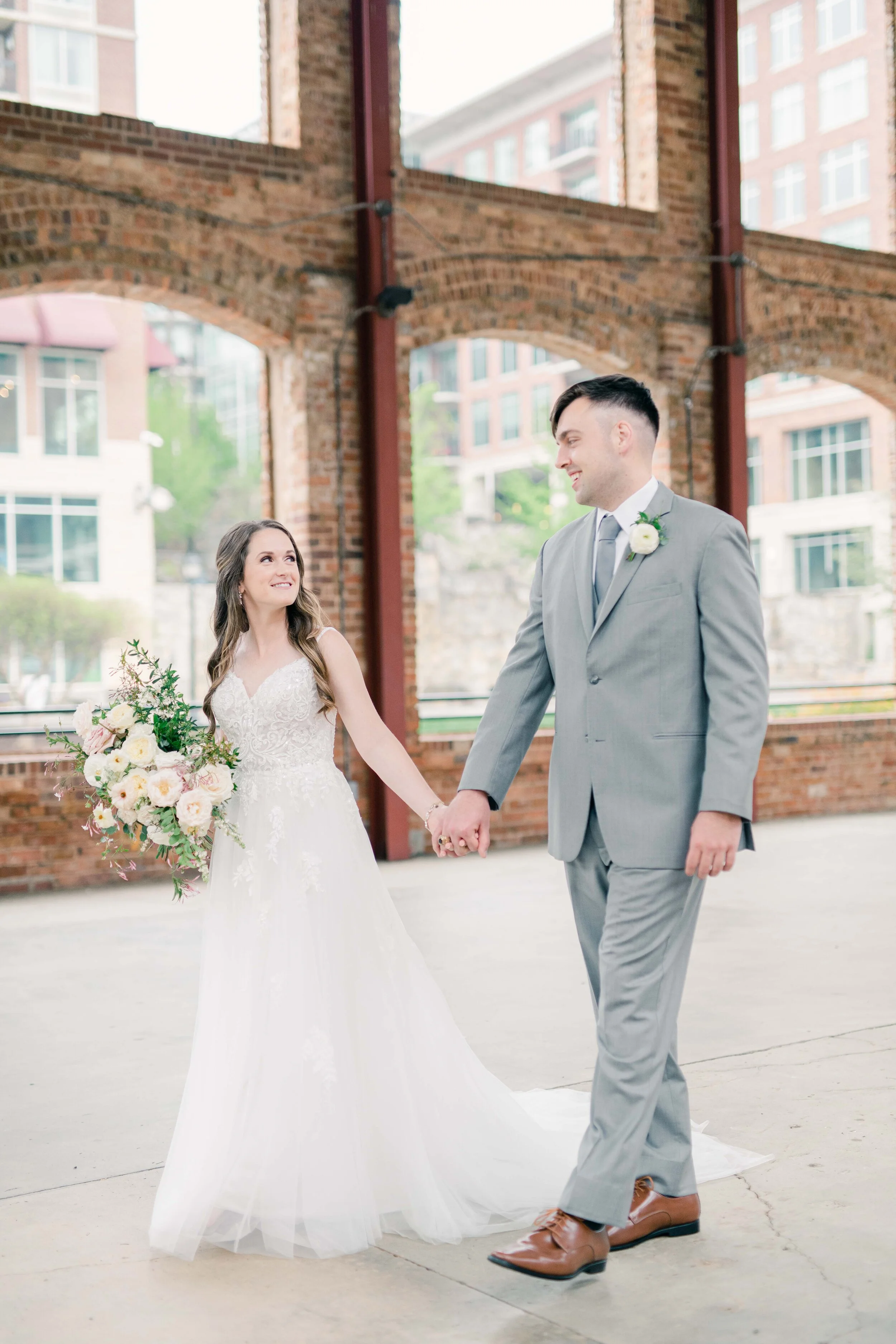 Champagne roses, cream garden roses, trailing jasmine, fluffy ranunculus, quicksand roses, majolica spray roses, and sage eucalyptus make up this gorgeous bridal bouquet. Designed by florist Rosemary & Finch in Nashville, TN.