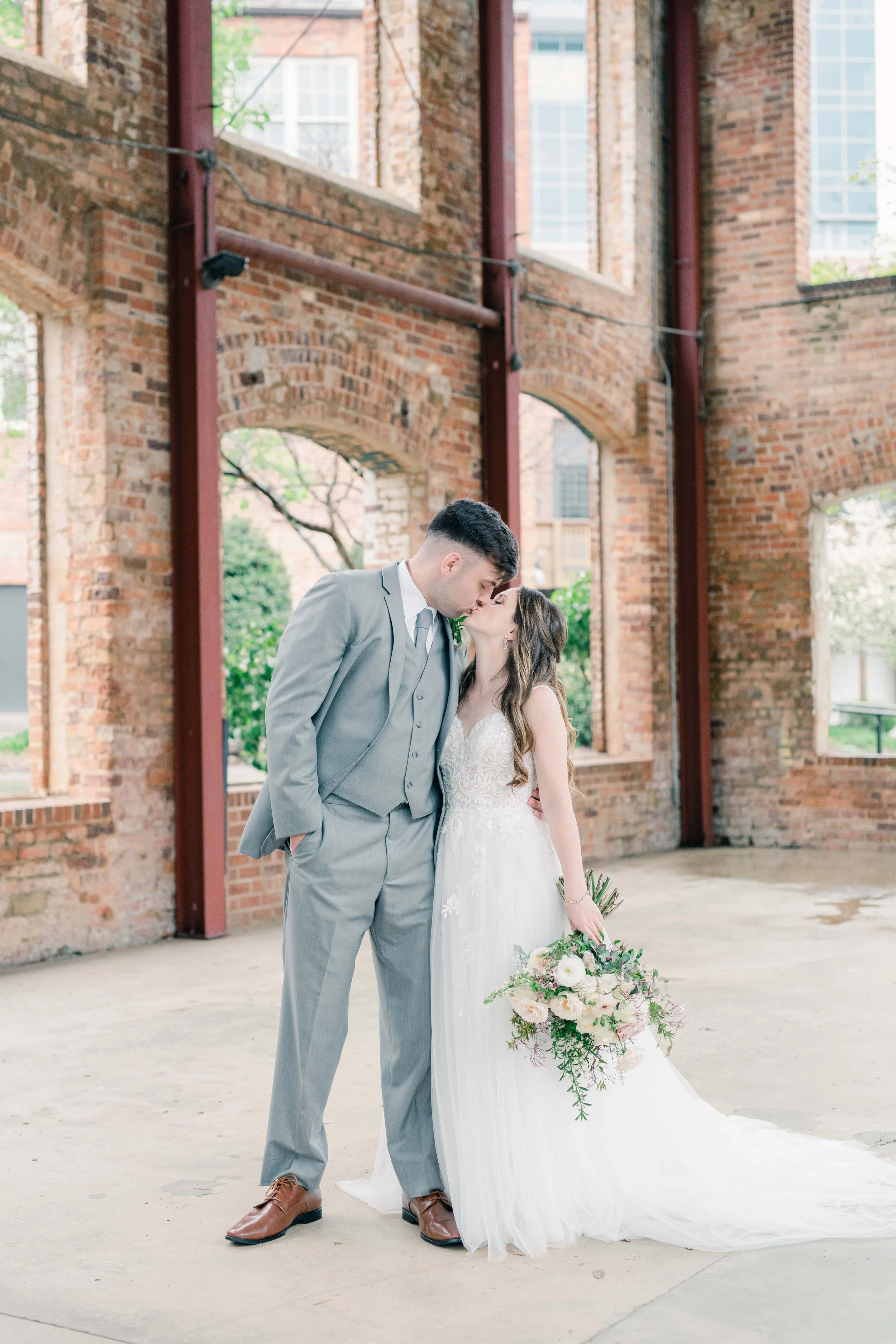 Champagne roses, cream garden roses, trailing jasmine, fluffy ranunculus, quicksand roses, majolica spray roses, and sage eucalyptus make up this gorgeous bridal bouquet. Designed by florist Rosemary & Finch in Nashville, TN.