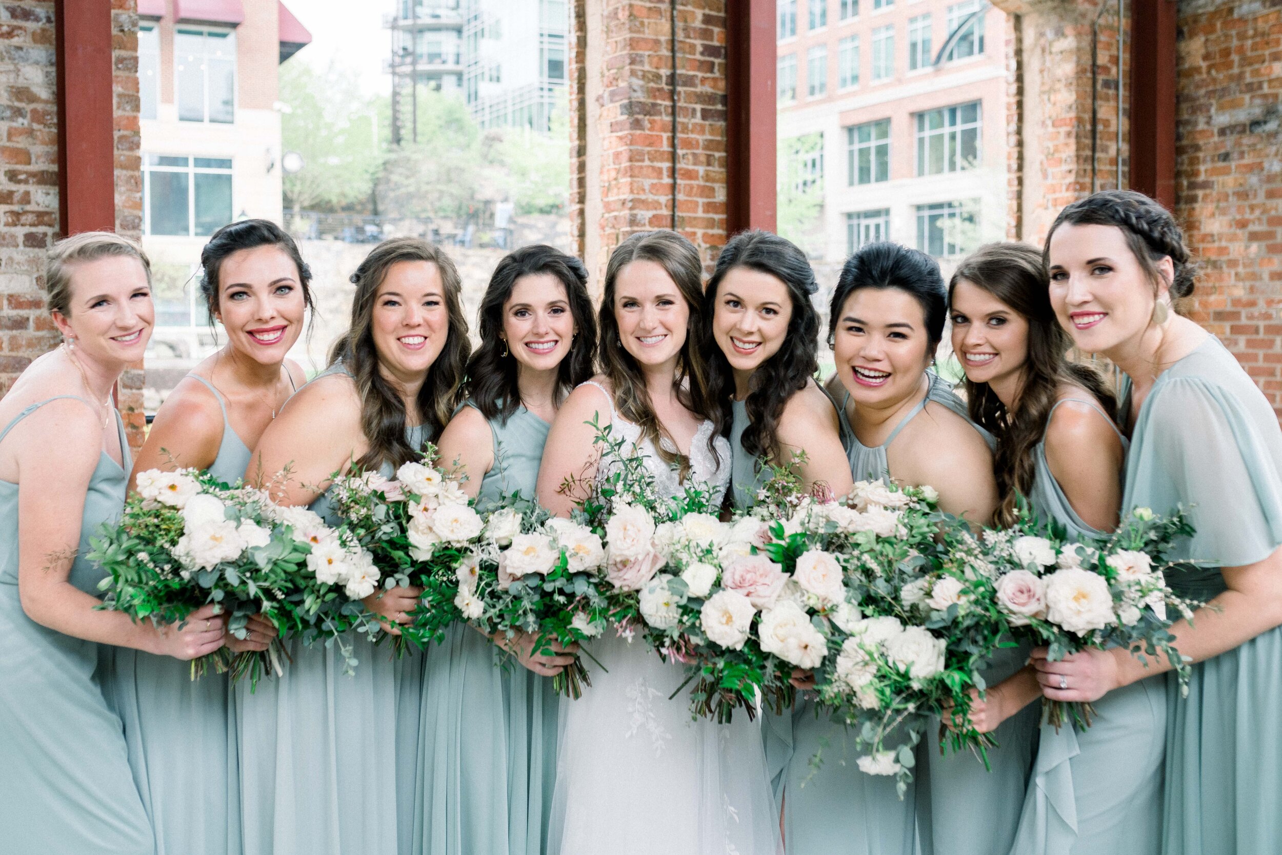 Champagne roses, cream garden roses, trailing jasmine, fluffy ranunculus, quicksand roses, majolica spray roses, and sage eucalyptus make up this gorgeous bridal bouquet. Designed by florist Rosemary & Finch in Nashville, TN.