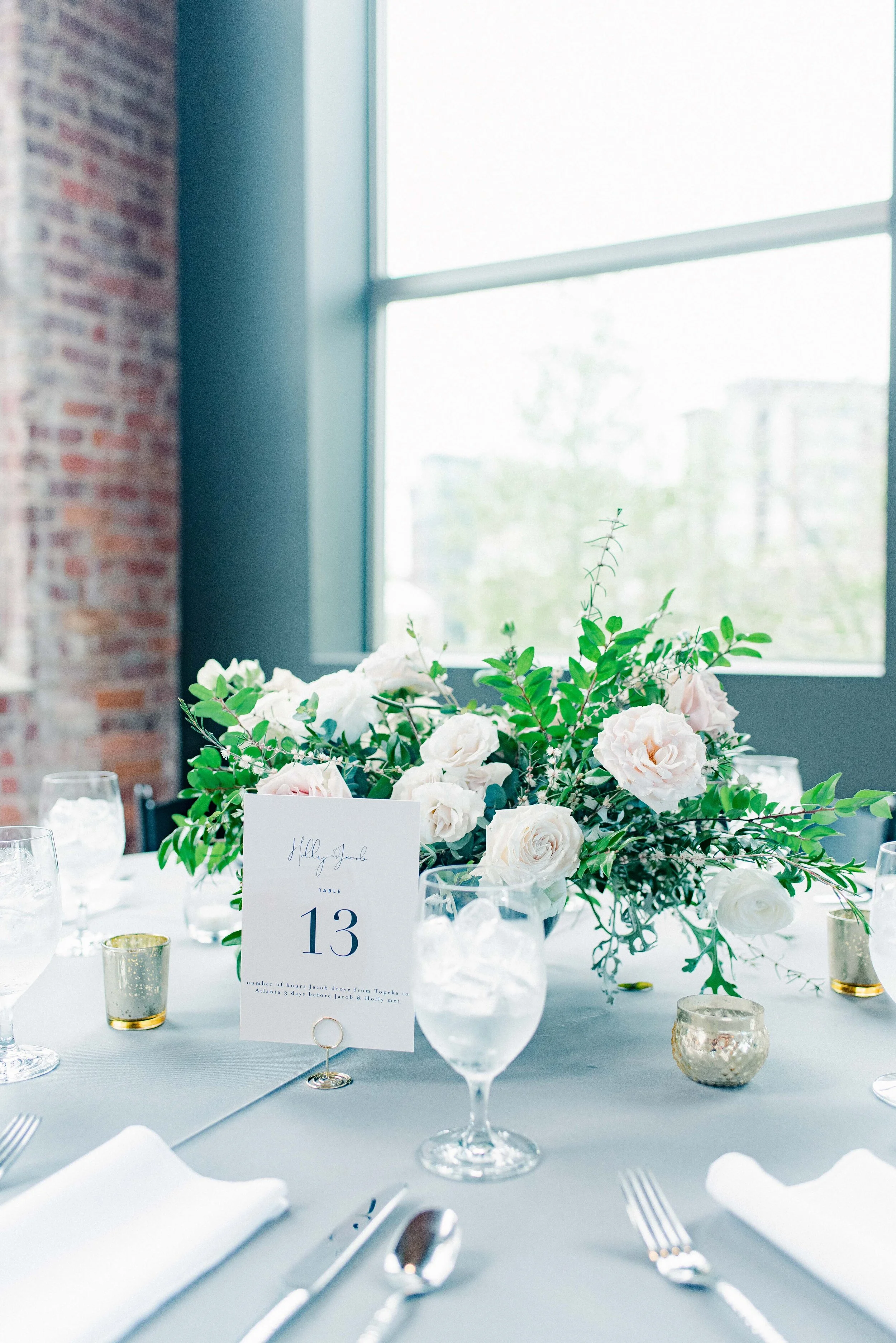 Table decor for this stunning wedding consisted of several different components. Round tables held lanterns adorned with blush and cream roses and lush greenery. Long, farm tables had garlands of eucalyptus and twinkling candles. Centerpieces filled…