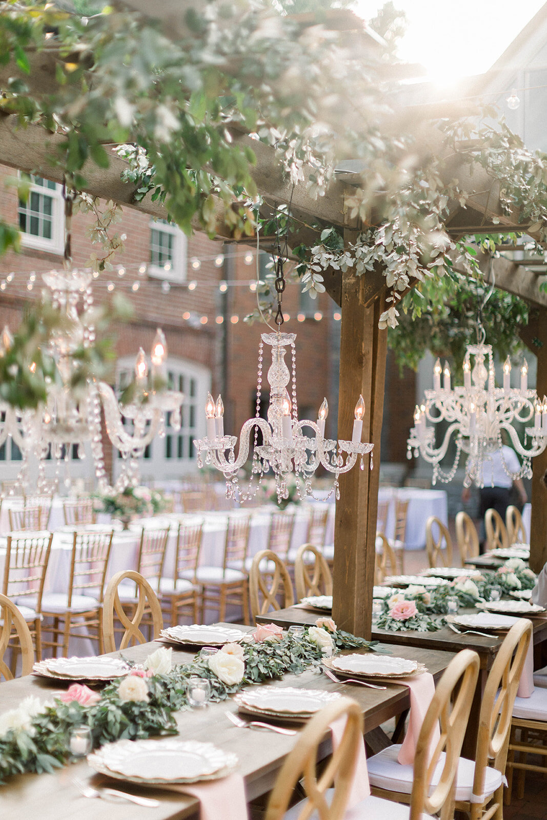 This garden courtyard reception pergola is covered with pink and ivory roses, majolica spray roses, heirloom carnations, assorted hydrangea and  cherry laurel. Designed by Rosemary & Finch in Nashville, TN.