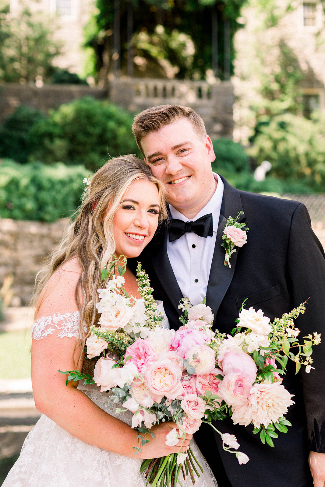 A lush bridal bouquet filled with hues of blush, pink, and ivory. Garden roses, majolica spray roses, champagne roses, peonies, picotee ranunculus, and spirea make up this fairytale bouquet. Designed by Rosemary & Finch in Nashville, TN.