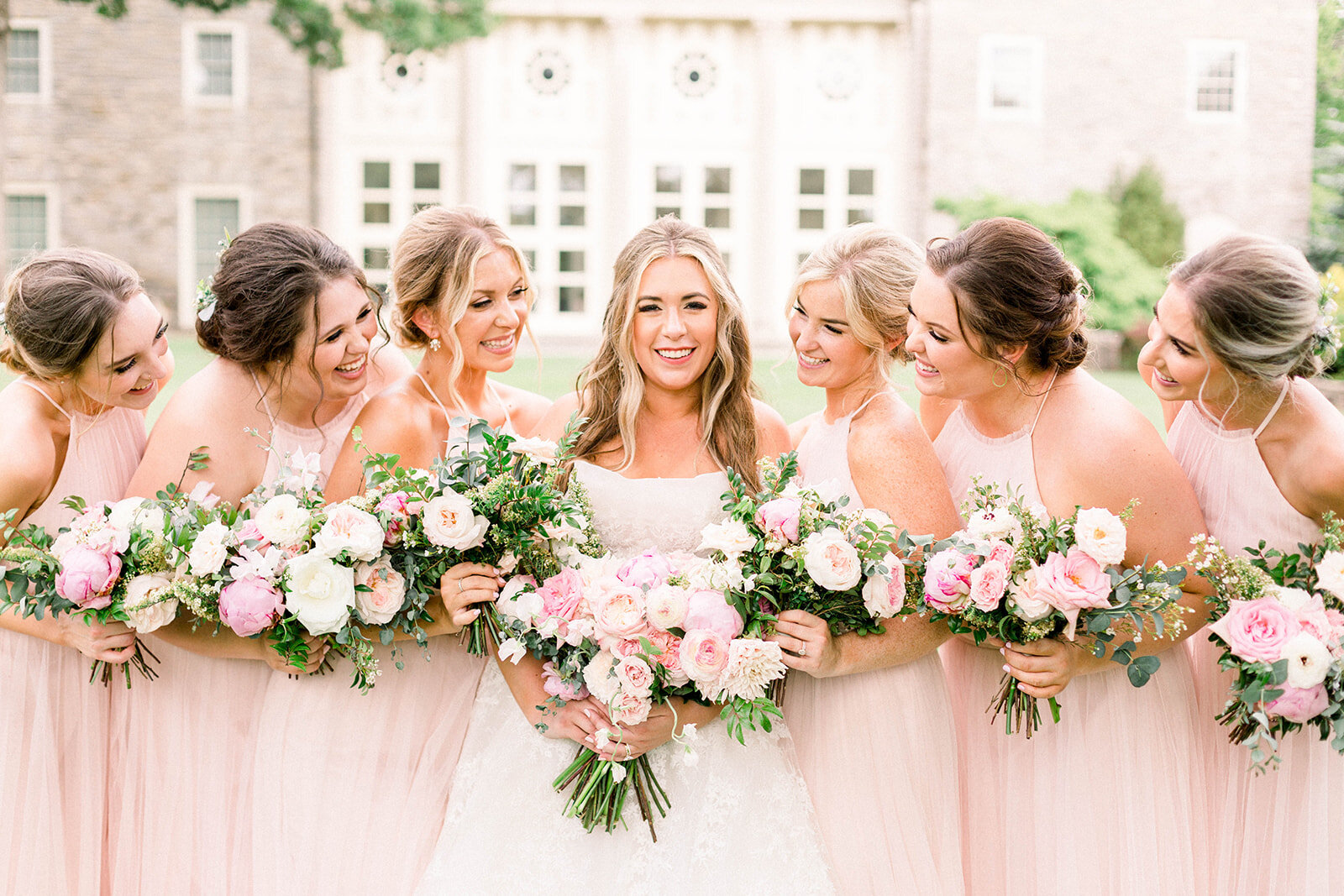 A lush bridal bouquet filled with hues of blush, pink, and ivory. Garden roses, majolica spray roses, champagne roses, peonies, picotee ranunculus, and spirea make up this fairytale bouquet. Designed by Rosemary & Finch in Nashville, TN.