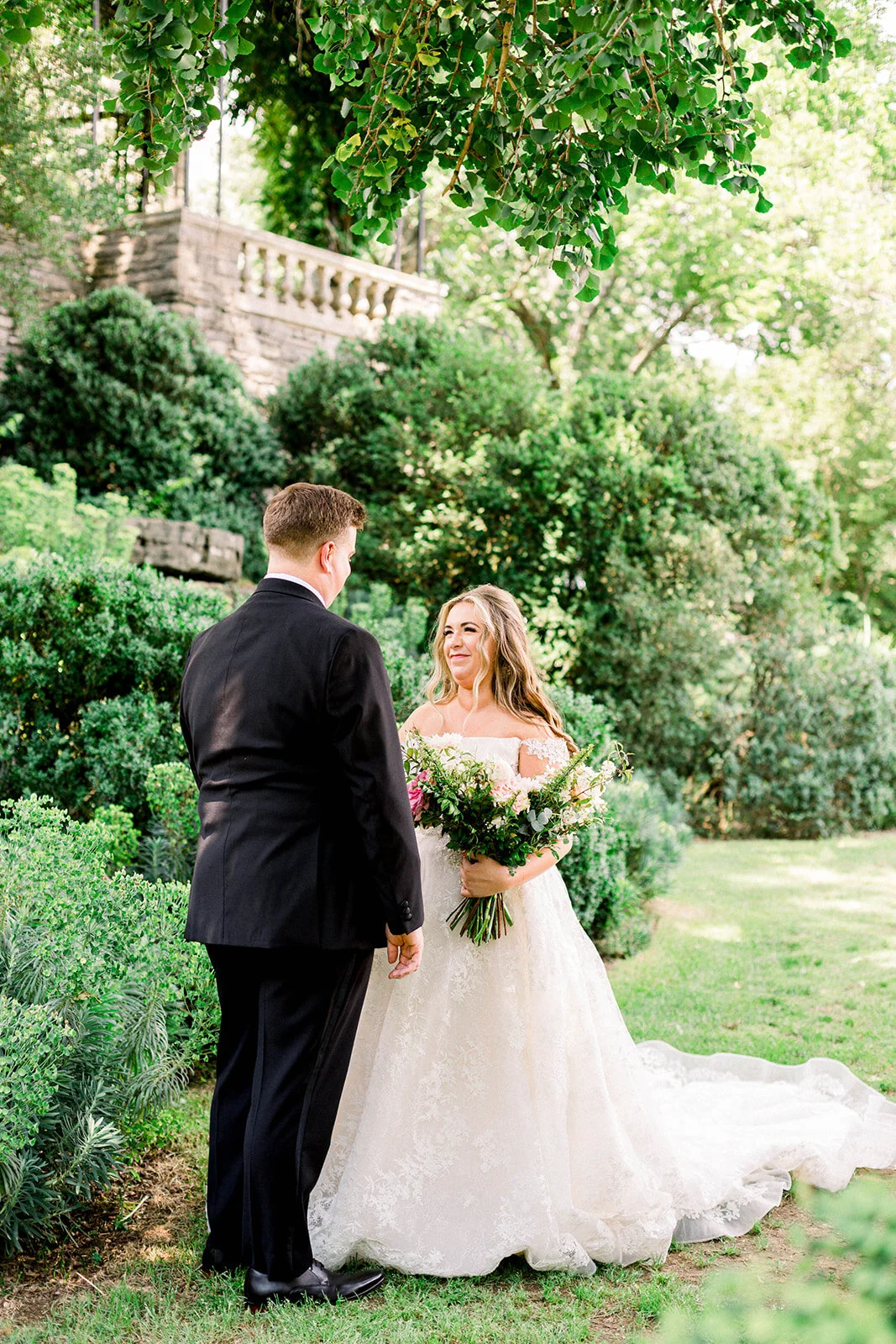 A lush bridal bouquet filled with hues of blush, pink, and ivory. Garden roses, majolica spray roses, champagne roses, peonies, picotee ranunculus, and spirea make up this fairytale bouquet. Designed by Rosemary & Finch in Nashville, TN.