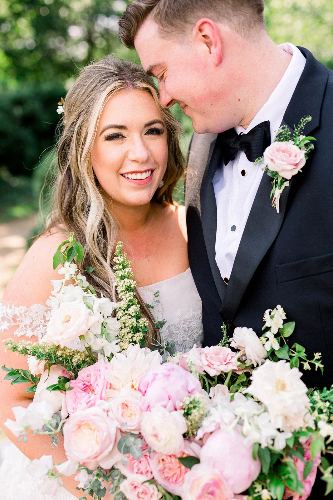 A lush bridal bouquet filled with hues of blush, pink, and ivory. Garden roses, majolica spray roses, champagne roses, peonies, picotee ranunculus, and spirea make up this fairytale bouquet. Designed by Rosemary & Finch in Nashville, TN.