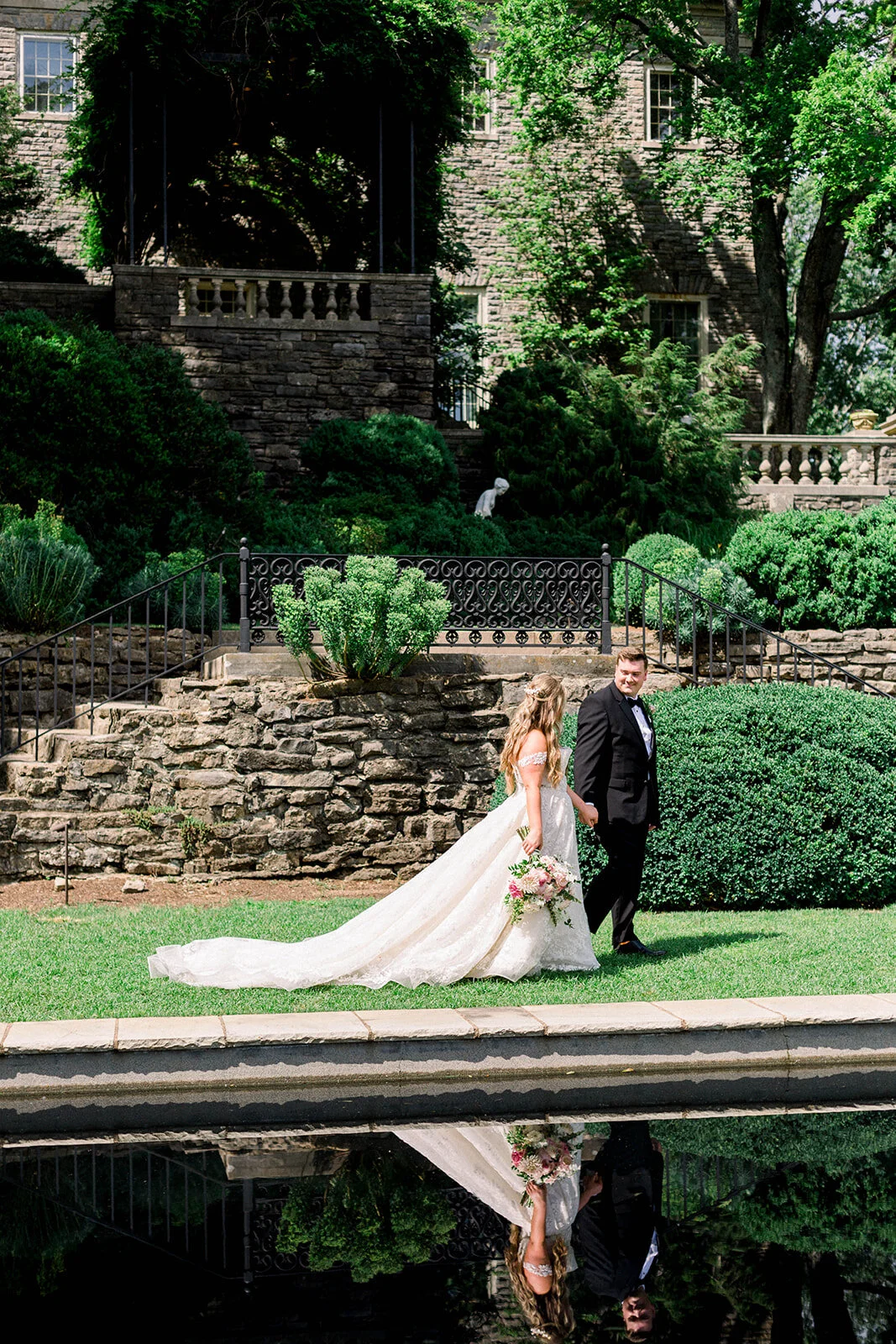 A lush bridal bouquet filled with hues of blush, pink, and ivory. Garden roses, majolica spray roses, champagne roses, peonies, picotee ranunculus, and spirea make up this fairytale bouquet. Designed by Rosemary & Finch in Nashville, TN.