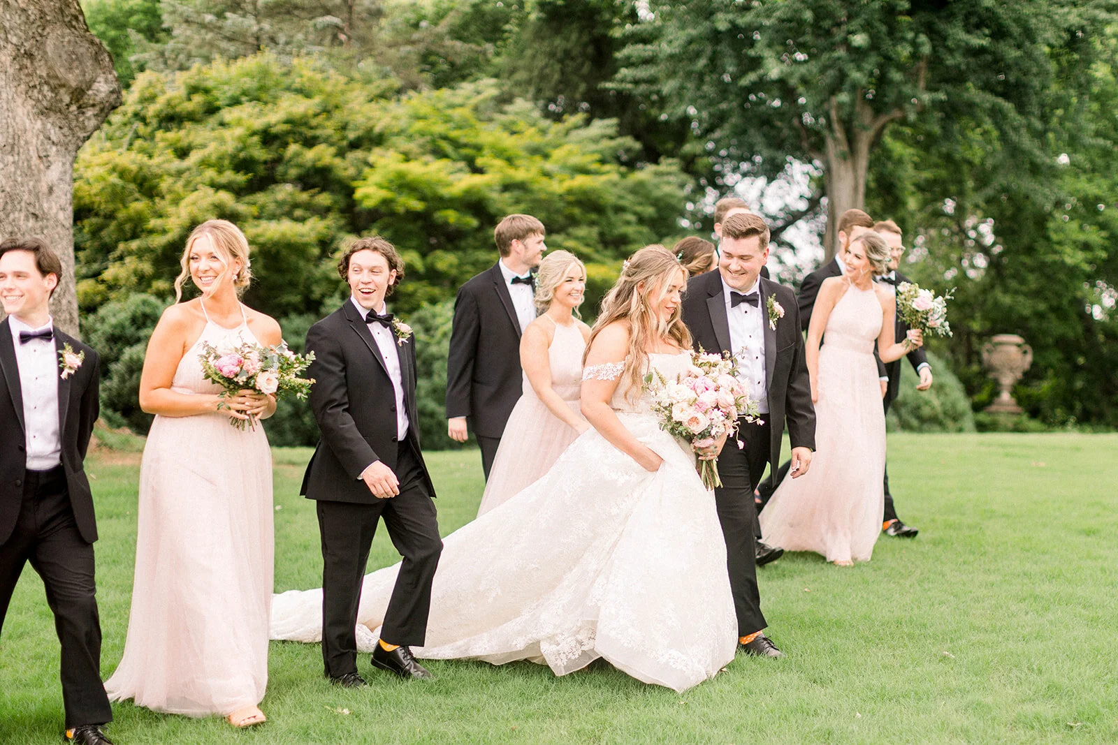 A lush bridal bouquet filled with hues of blush, pink, and ivory. Garden roses, majolica spray roses, champagne roses, peonies, picotee ranunculus, and spirea make up this fairytale bouquet. Designed by Rosemary & Finch in Nashville, TN.