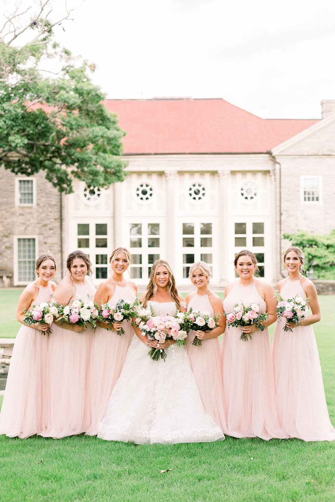 A lush bridal bouquet filled with hues of blush, pink, and ivory. Garden roses, majolica spray roses, champagne roses, peonies, picotee ranunculus, and spirea make up this fairytale bouquet. Designed by Rosemary & Finch in Nashville, TN.