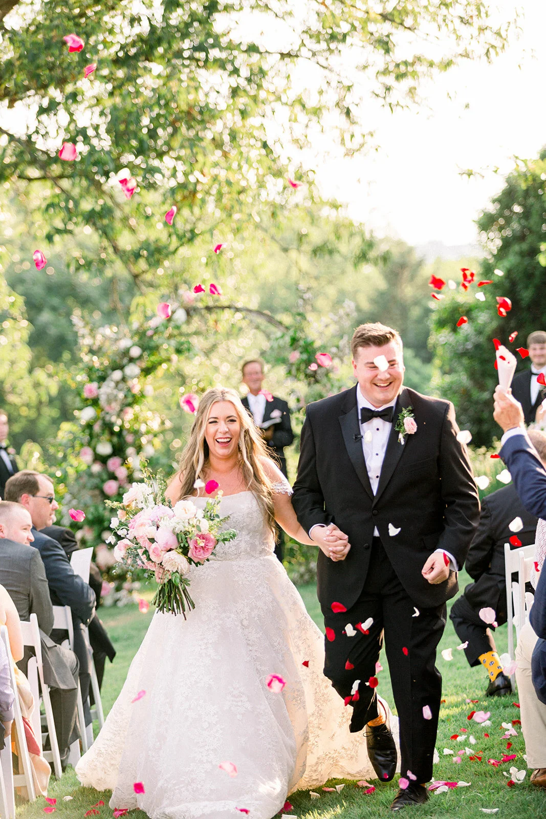 A lush bridal bouquet filled with hues of blush, pink, and ivory. Garden roses, majolica spray roses, champagne roses, peonies, picotee ranunculus, and spirea make up this fairytale bouquet. Designed by Rosemary & Finch in Nashville, TN.