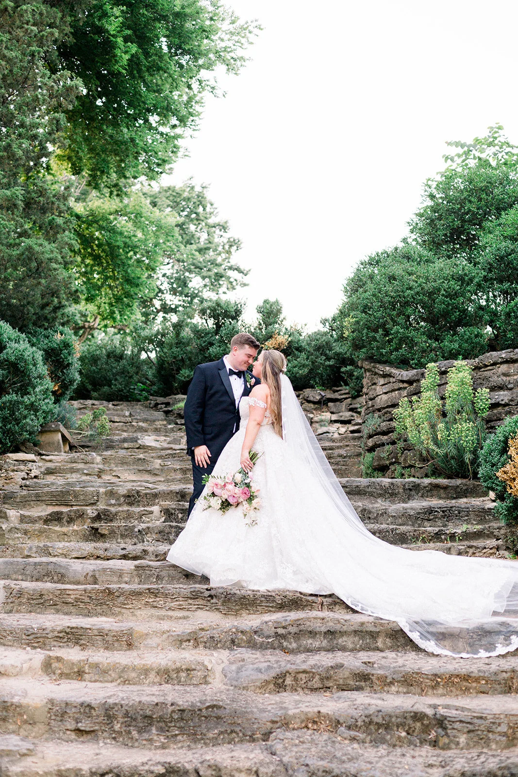 A lush bridal bouquet filled with hues of blush, pink, and ivory. Garden roses, majolica spray roses, champagne roses, peonies, picotee ranunculus, and spirea make up this fairytale bouquet. Designed by Rosemary & Finch in Nashville, TN.