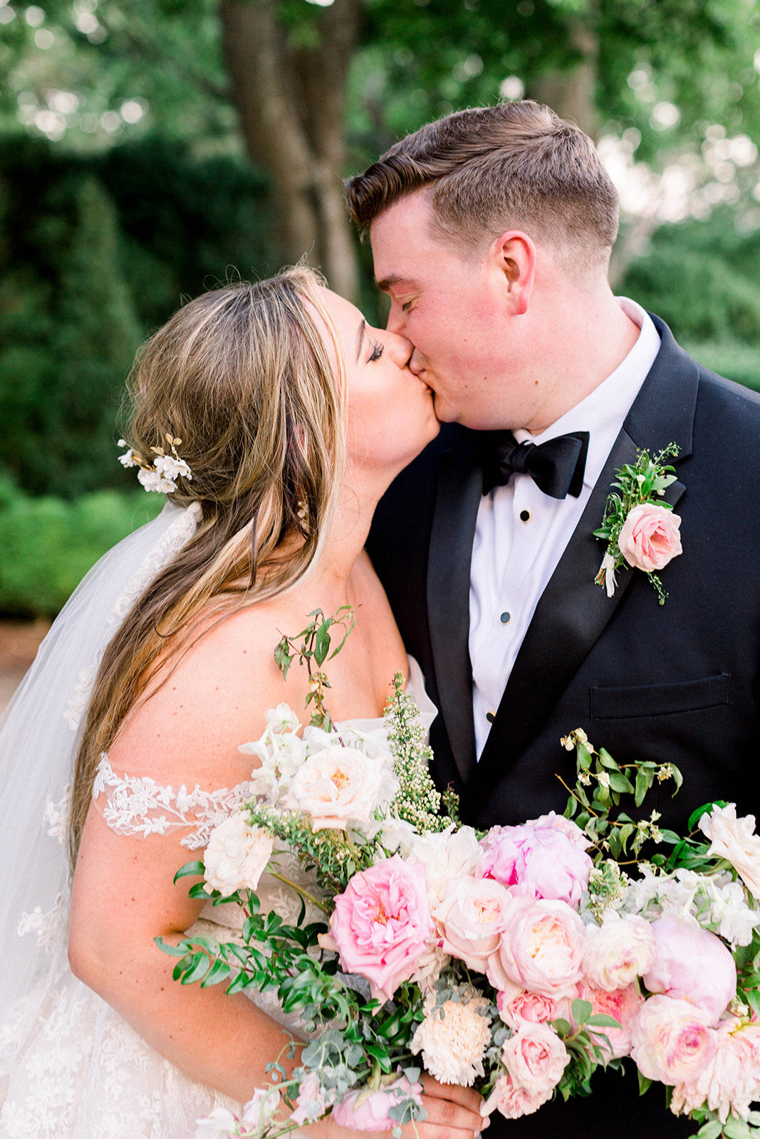 A lush bridal bouquet filled with hues of blush, pink, and ivory. Garden roses, majolica spray roses, champagne roses, peonies, picotee ranunculus, and spirea make up this fairytale bouquet. Designed by Rosemary & Finch in Nashville, TN.