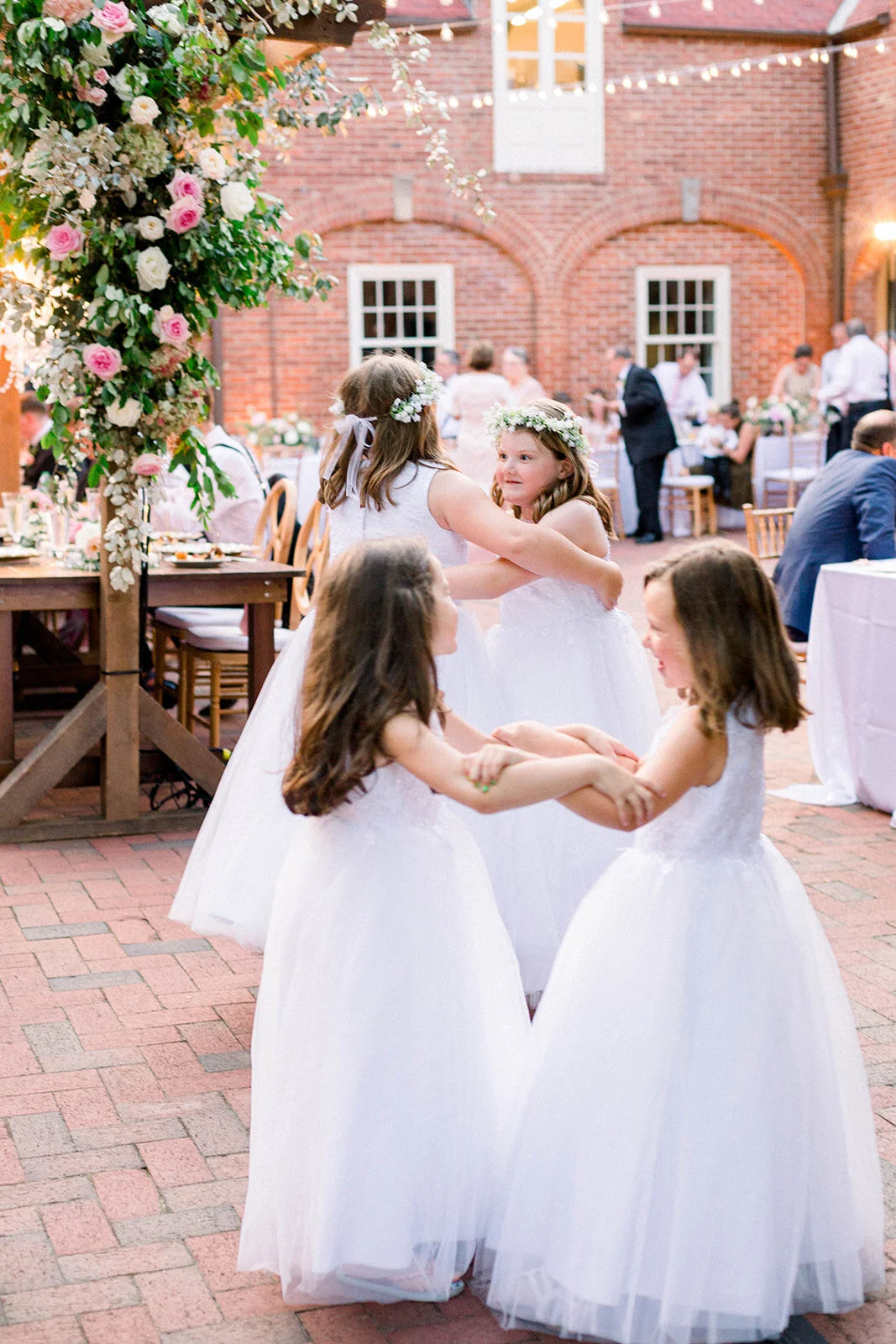 This garden courtyard reception pergola is covered with pink and ivory roses, majolica spray roses, heirloom carnations, assorted hydrangea and  cherry laurel. Designed by Rosemary & Finch in Nashville, TN.