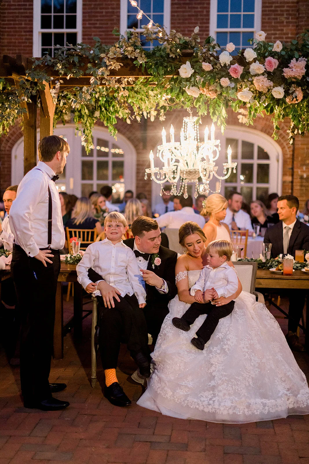 This garden courtyard reception pergola is covered with pink and ivory roses, majolica spray roses, heirloom carnations, assorted hydrangea and  cherry laurel. Designed by Rosemary & Finch in Nashville, TN.