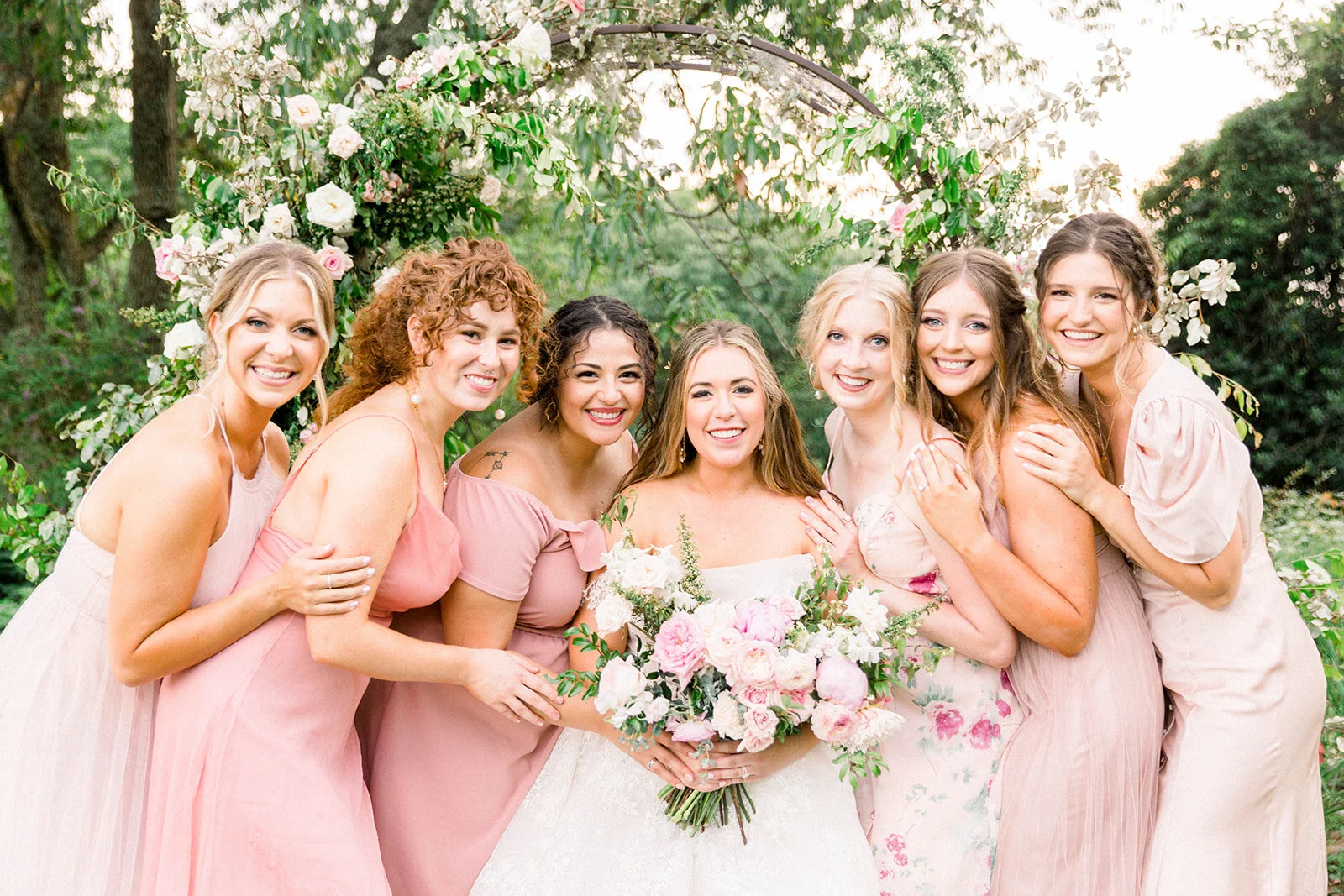 A lush bridal bouquet filled with hues of blush, pink, and ivory. Garden roses, majolica spray roses, champagne roses, peonies, picotee ranunculus, and spirea make up this fairytale bouquet. Designed by Rosemary & Finch in Nashville, TN.
