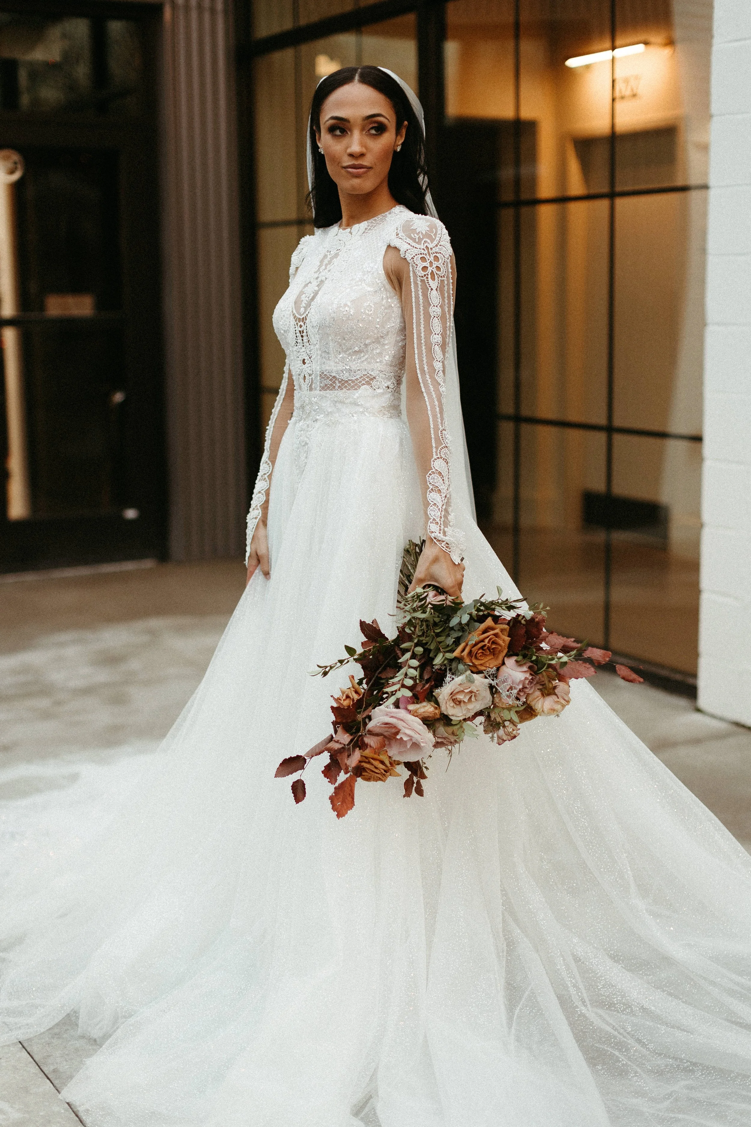 This elegant bridal bouquet brought hues of mauve, dusty pink, cream, burgundy, and terra cotta to this winter wedding. Lush with petal heavy roses, ranunculus, spray roses, copper beech, and greenery. Designed by Rosemary and Finch in Nashville, TN.