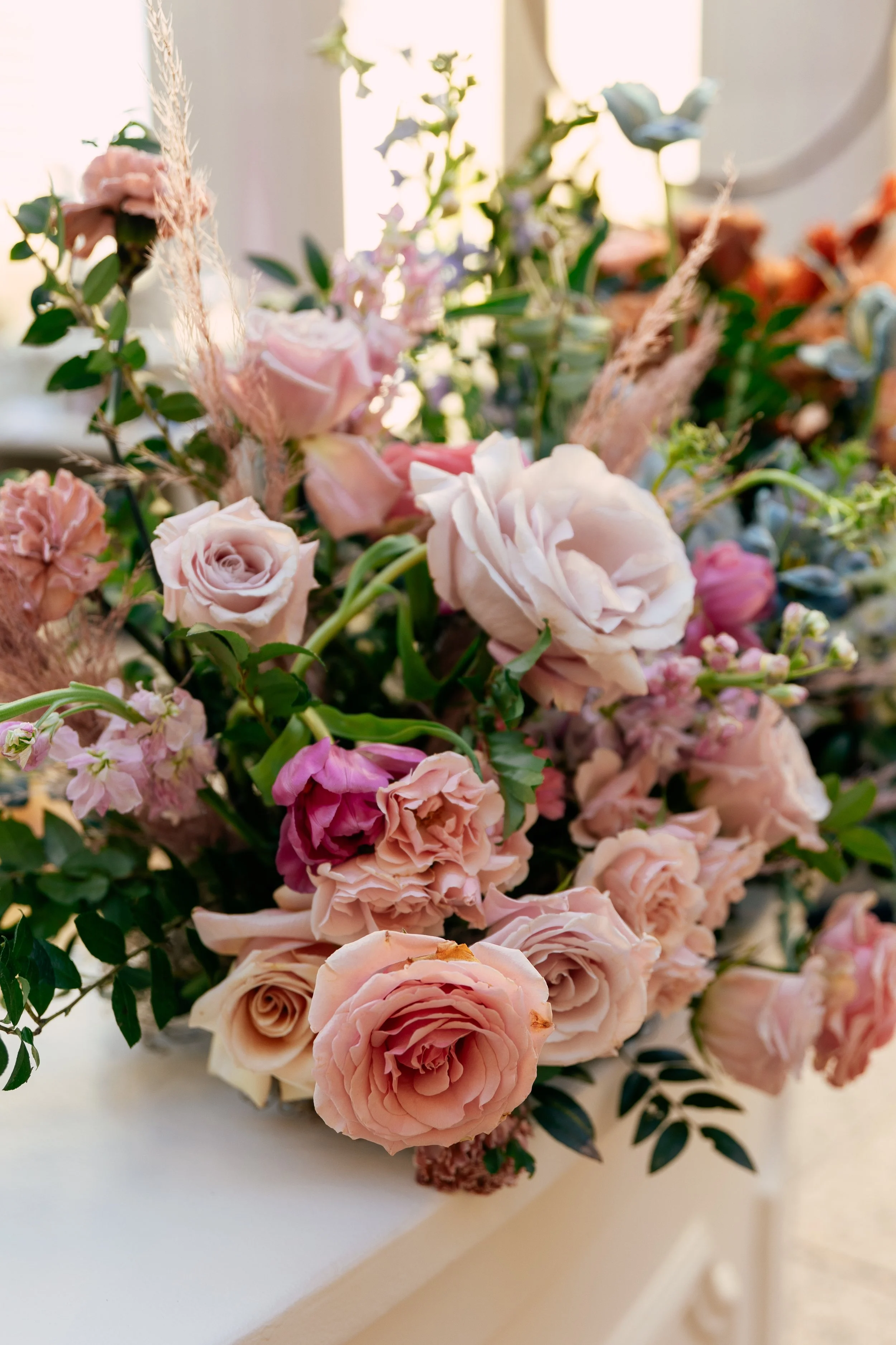 Bright and colorful arrangements create an inviting scene for guests at the TPAC Gala in Nashville Tennessee. Florals composed of roses, hydrangeas, tulips, snapdragons, dried palm, and anthurium. Designed by Rosemary and Finch.