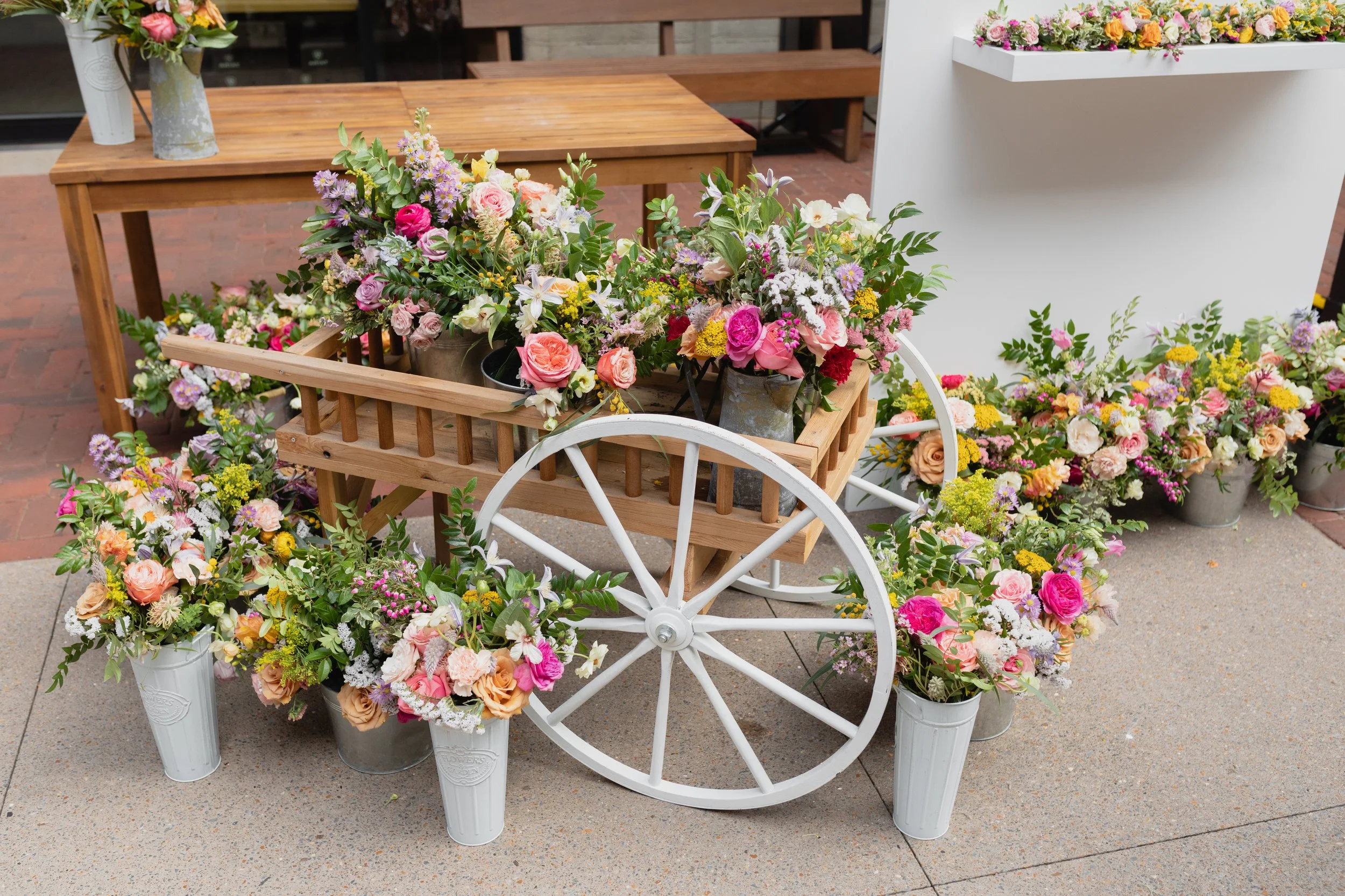Bright spring floral hues of pink, lavender, coral, magenta, and yellow inspire the event space of Fifth + Broadway in Nashville, TN. Florals composed of roses, ranunculus, sweet peas, butterfly ranunculus, mixed greenery. Design by Rosemary and Finc