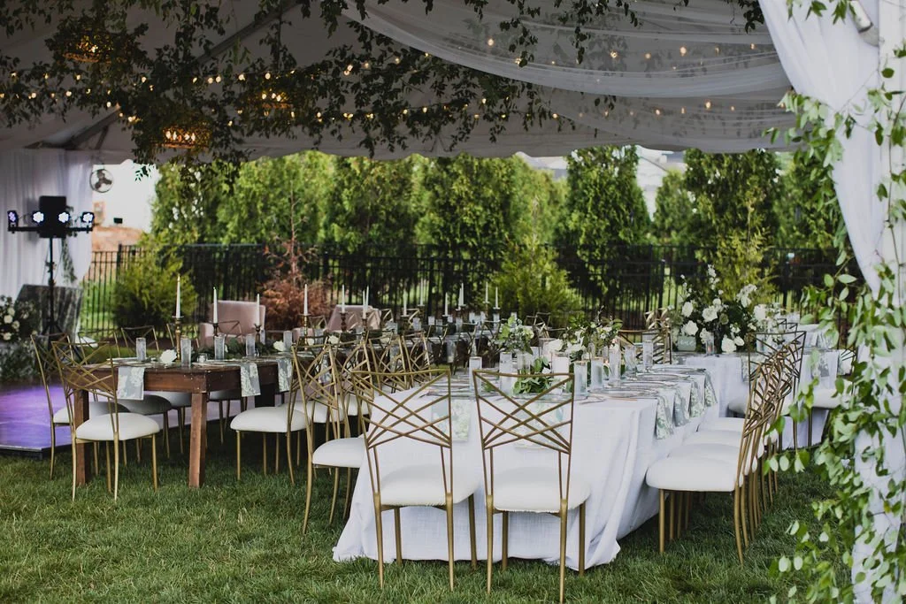 Gorgeous installations of smilax grew over the entrance to the tent, on the chandeliers, and all throughout the reception creating a warm, natural atmosphere. Designed by Rosemary and Finch in Nashville, TN.