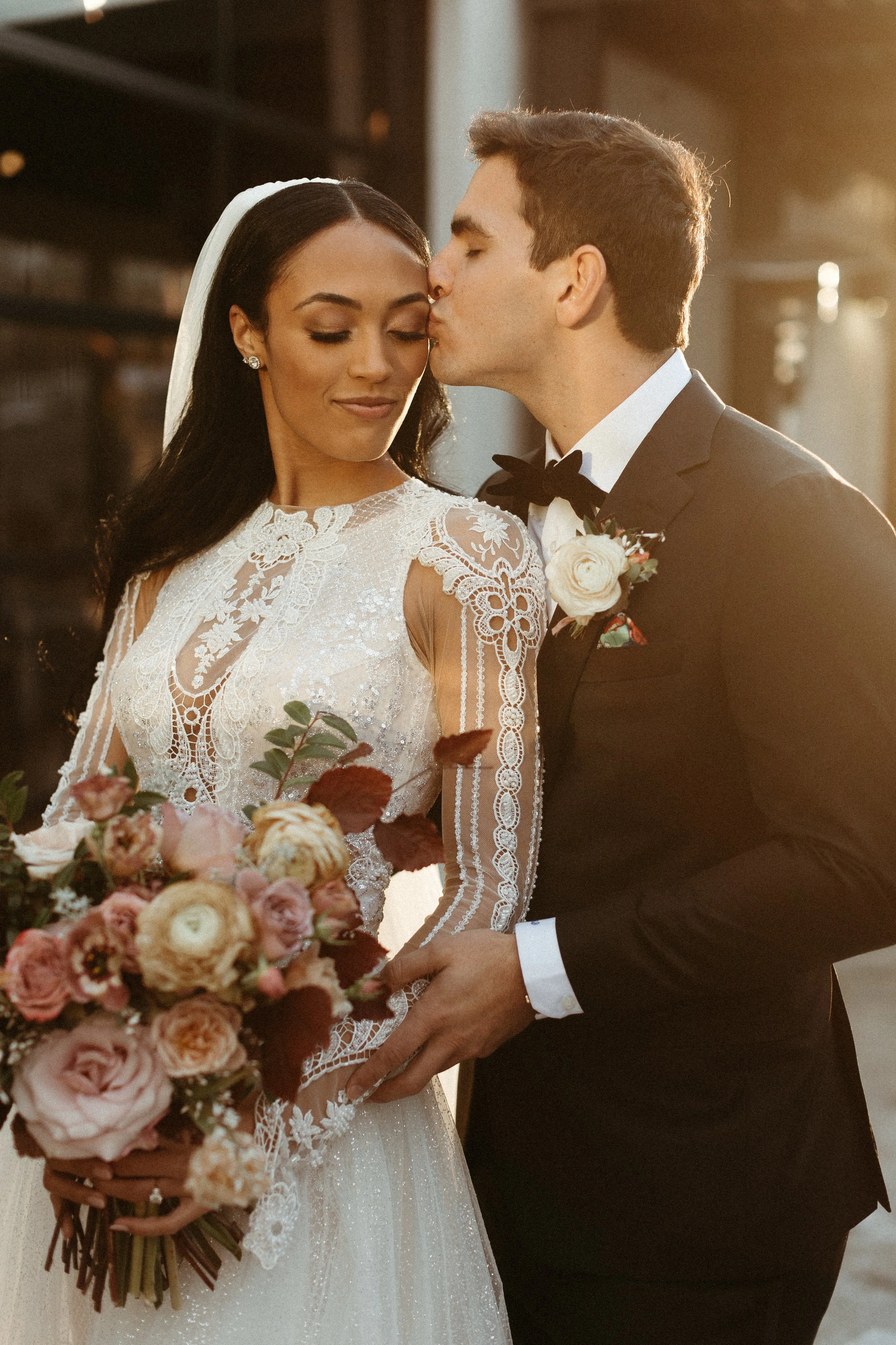 This elegant bridal bouquet brought hues of mauve, dusty pink, cream, burgundy, and terra cotta to this winter wedding. Lush with petal heavy roses, ranunculus, spray roses, copper beech, and greenery. Designed by Rosemary and Finch in Nashville, TN.