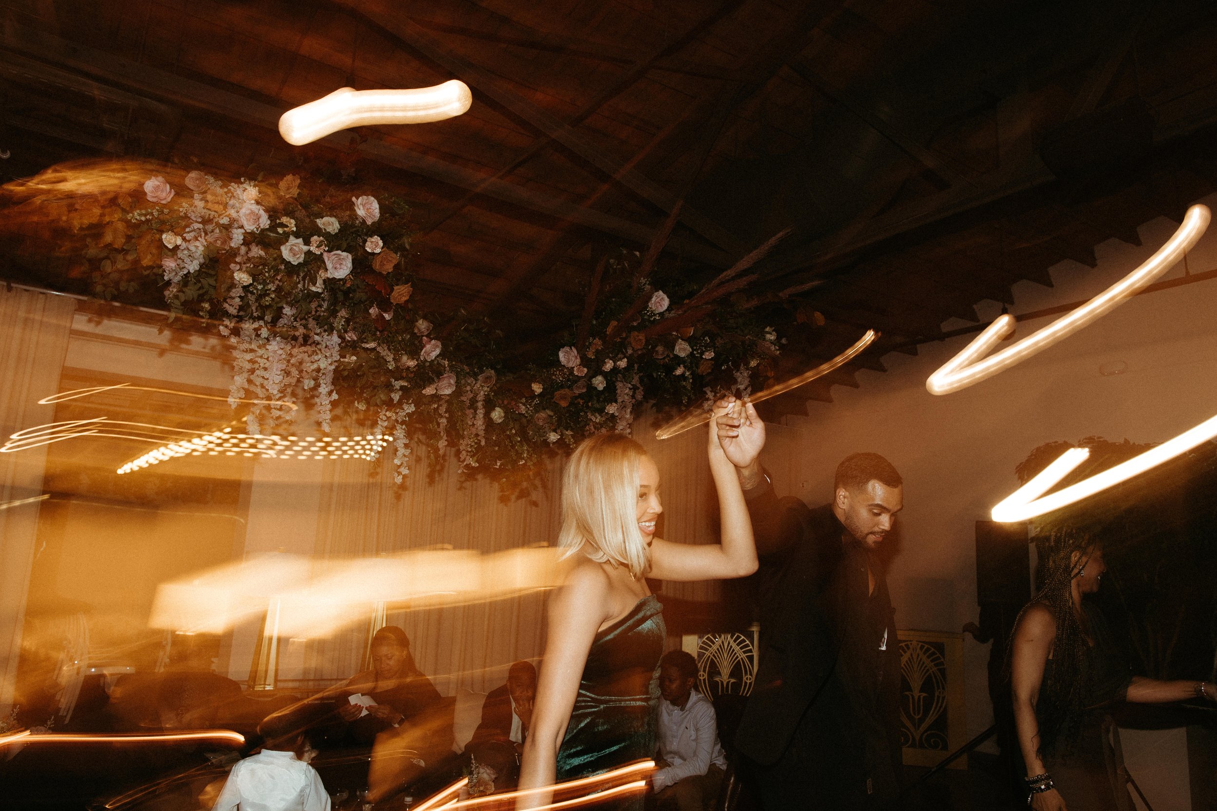 Stunning floral installations bring warmth to this Great Gatsby inspired wedding with florals of terra cotta, dusty pink, and burgundy hues. Petal heavy roses, wisteria, copper beech, and pink pampas grass accents. Designed by Rosemary and Finch in N