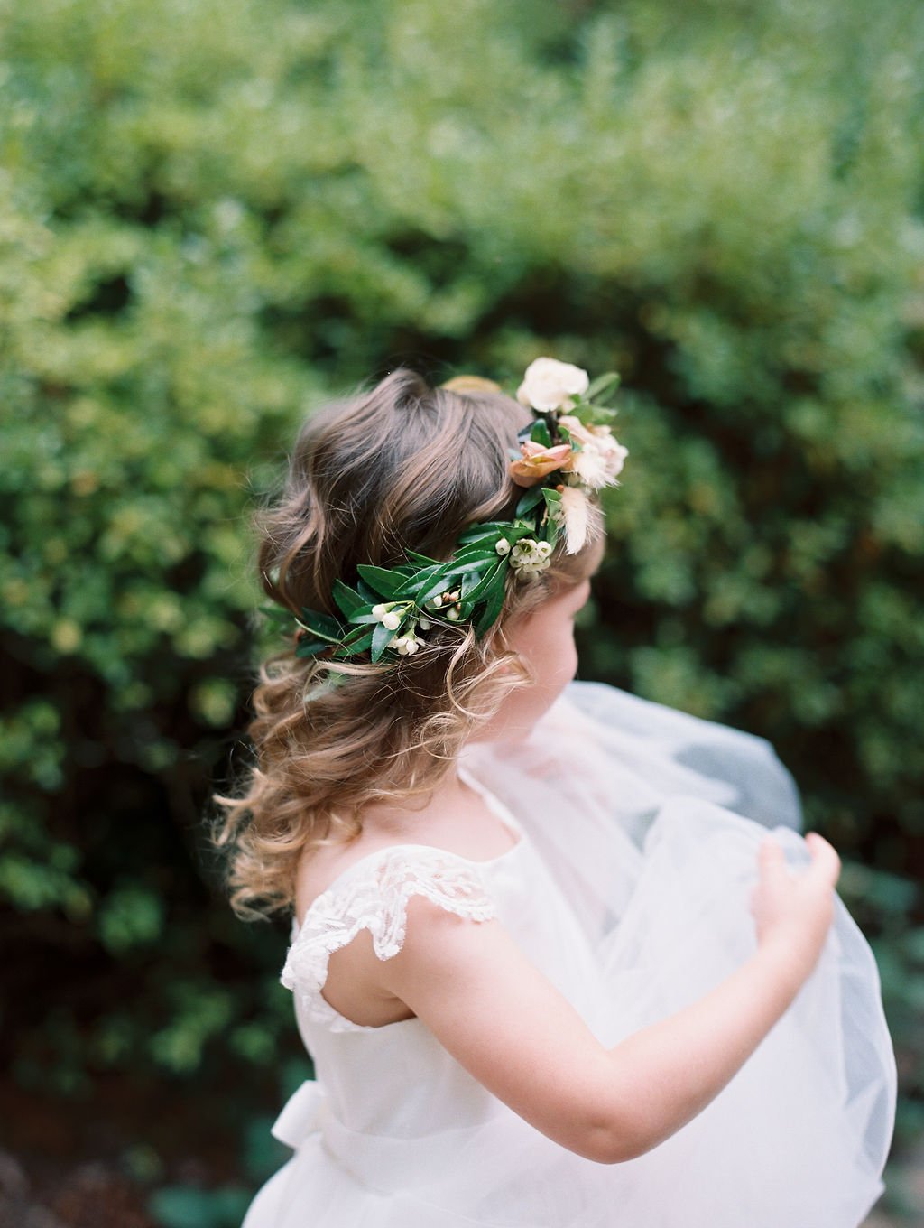 Flower girl crown featuring natural greenery, roses and wax flower. Nashville wedding florist at RT Lodge.