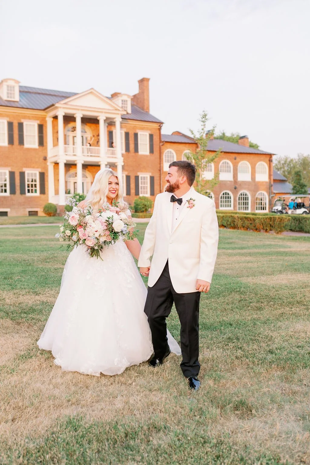 A lush bridal bouquet filled with hues of blush, pink, ivory, and hints of French blue. Garden roses, majolica spray roses, champagne roses, peonies, ranunculus, delphinium, and spirea make up this fairytale bouquet. Designed by Rosemary & Finch in N