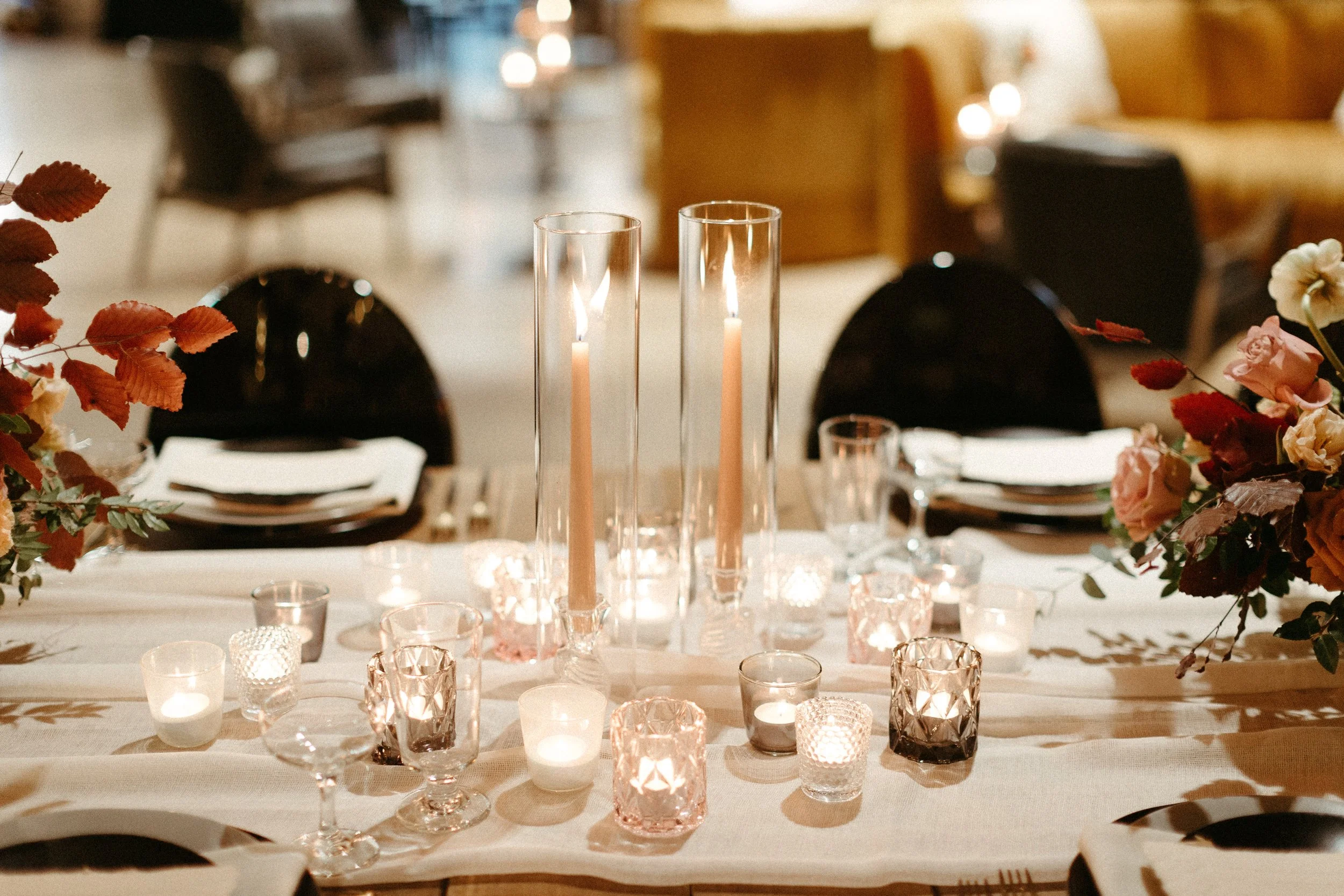 1920s and Great Gatsby inspired tablescapes are highlighted by gorgeous gold candlesticks, blush tapers, and taupe and bronze votives. Designed with floral hues of terra cotta, mauve, and dusty rose. Designed by Rosemary and Finch in Nashville, TN.