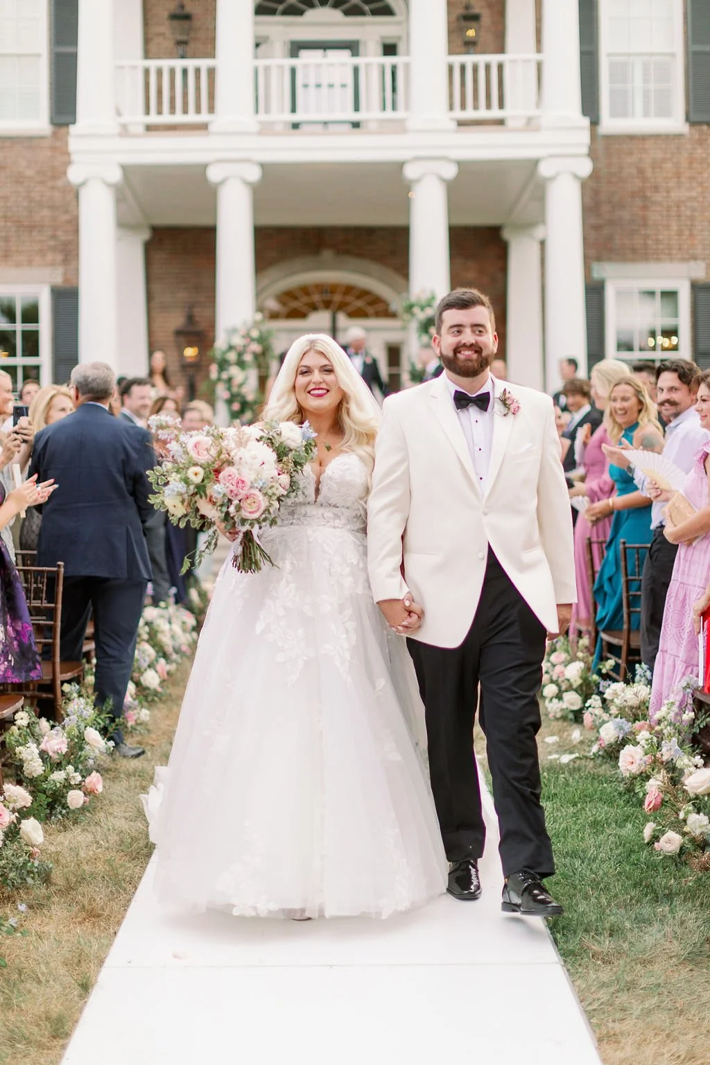 A lush bridal bouquet filled with hues of blush, pink, ivory, and hints of French blue. Garden roses, majolica spray roses, champagne roses, peonies, ranunculus, delphinium, and spirea make up this fairytale bouquet. Designed by Rosemary & Finch in N
