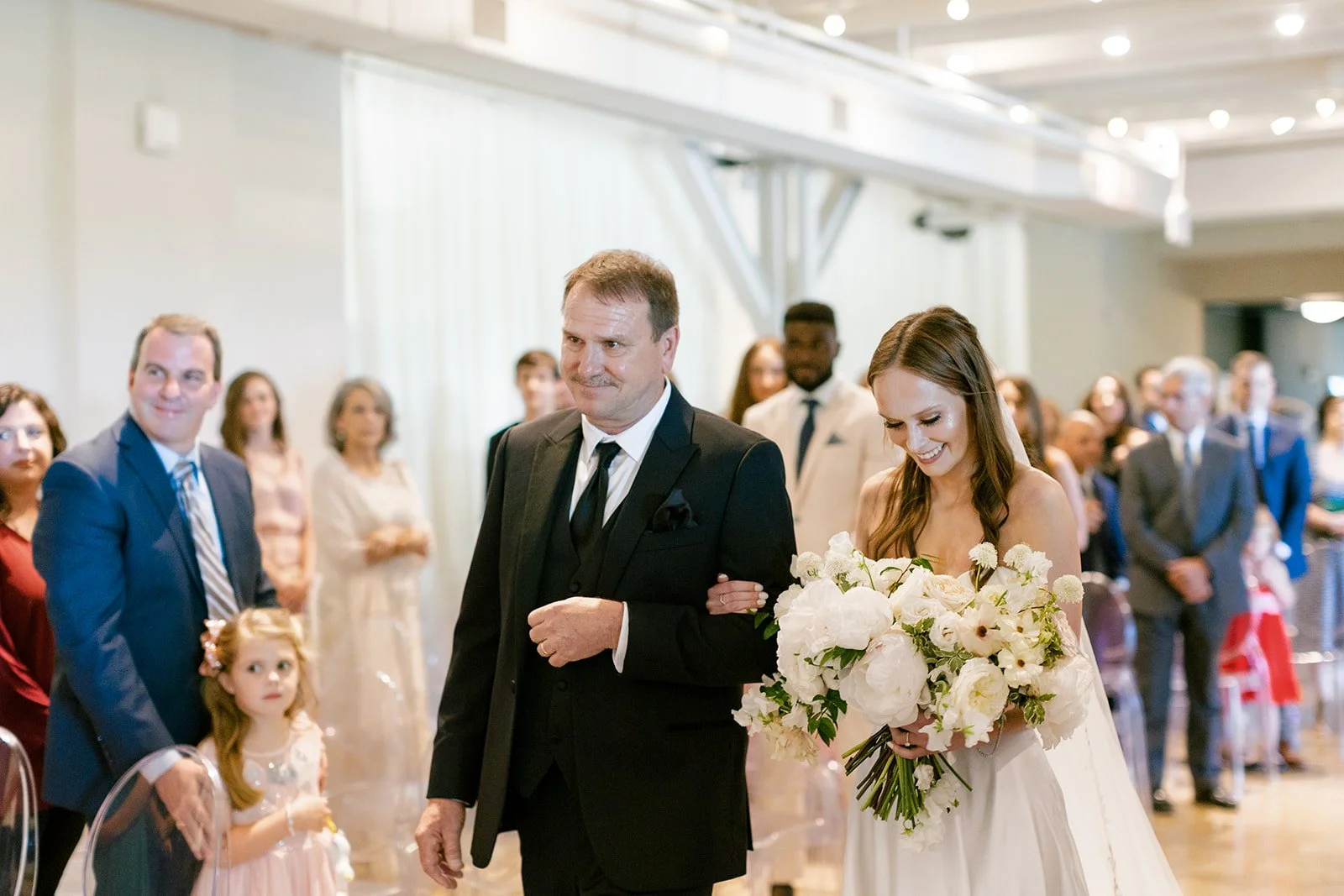 Bridal bouquet of white garden roses, peonies, ranunculus, sweet peas, scabiosa, butterfly ranunculus and dark greenery in floral hues of white, cream, and blush. Designed by Rosemary and Finch in Nashville, TN.