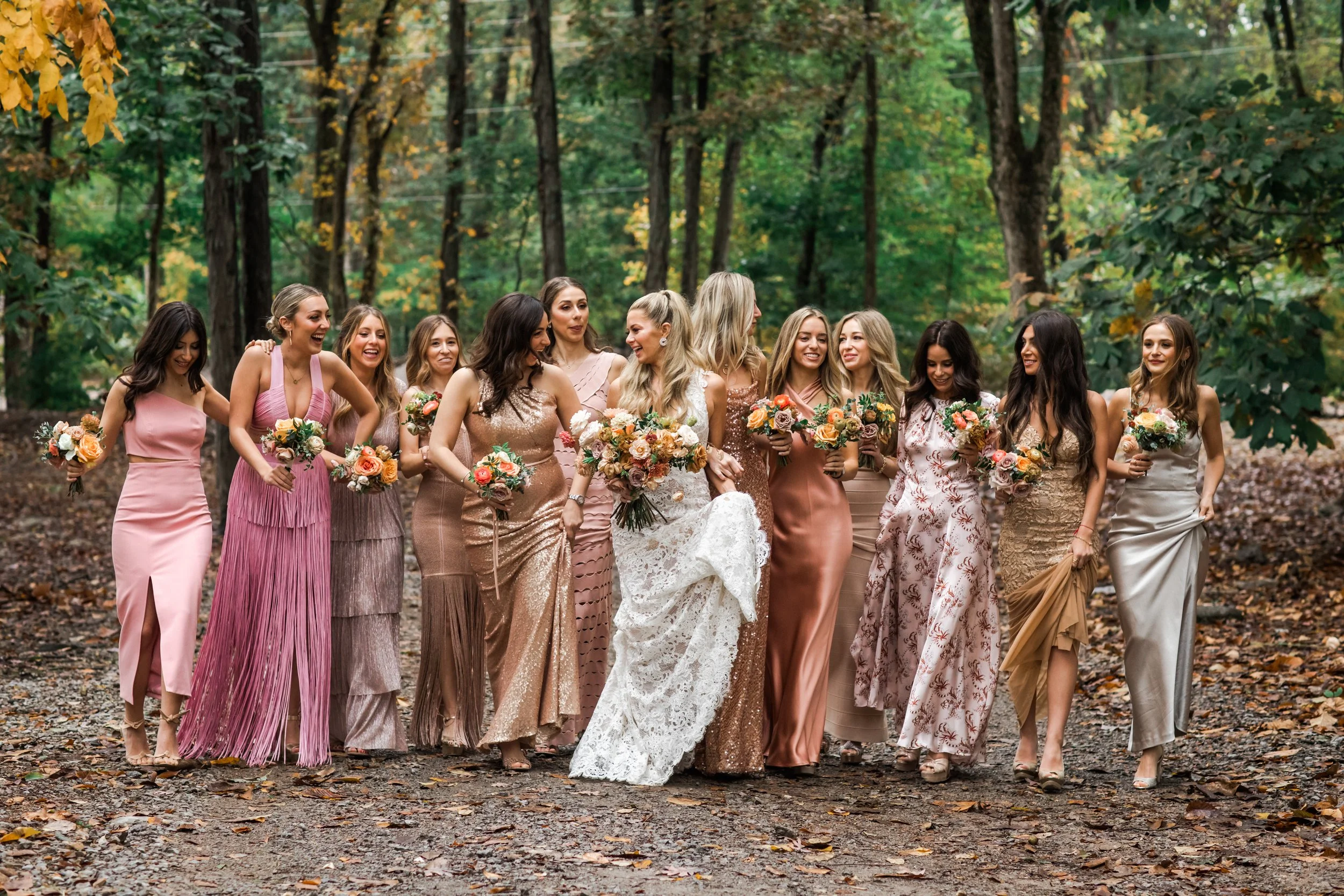 An elegant fall bridal bouquet featuring a sunset color palette of blush, terra cotta, rose gold, yellow, and copper. Florals accents of dahlias, garden roses, ranunculus, and double brownie tulips. Designed by Rosemary and Finch in Nashville, TN.
