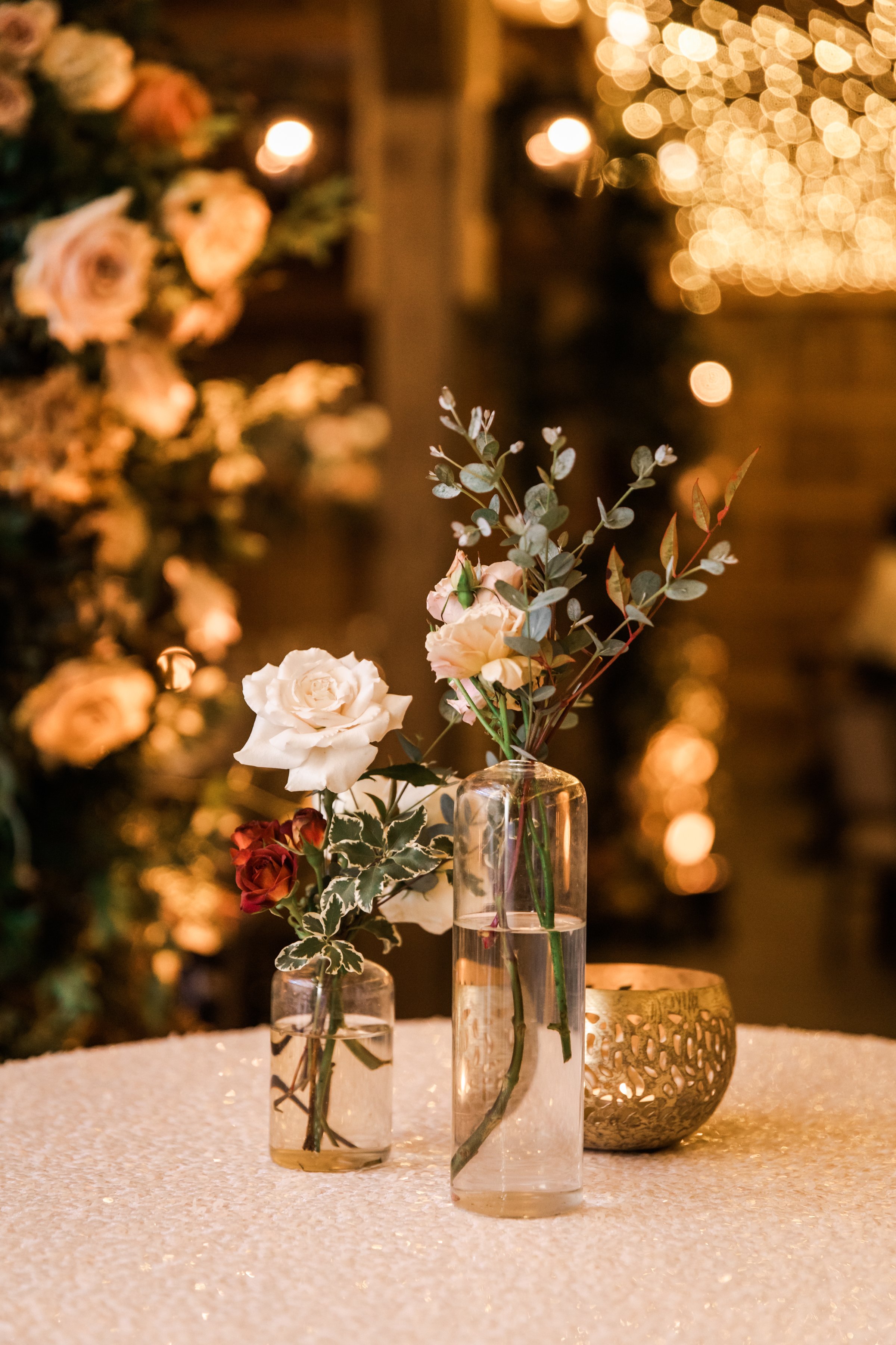 Elegant accents of fall florals, including roses, dahlias, and fall greenery, decorate the reception space of this autumnal wedding. Hues of terra cotta, rose gold, yellow, copper, and dusty pink. Designed by Rosemary and Finch in Nashville, TN.