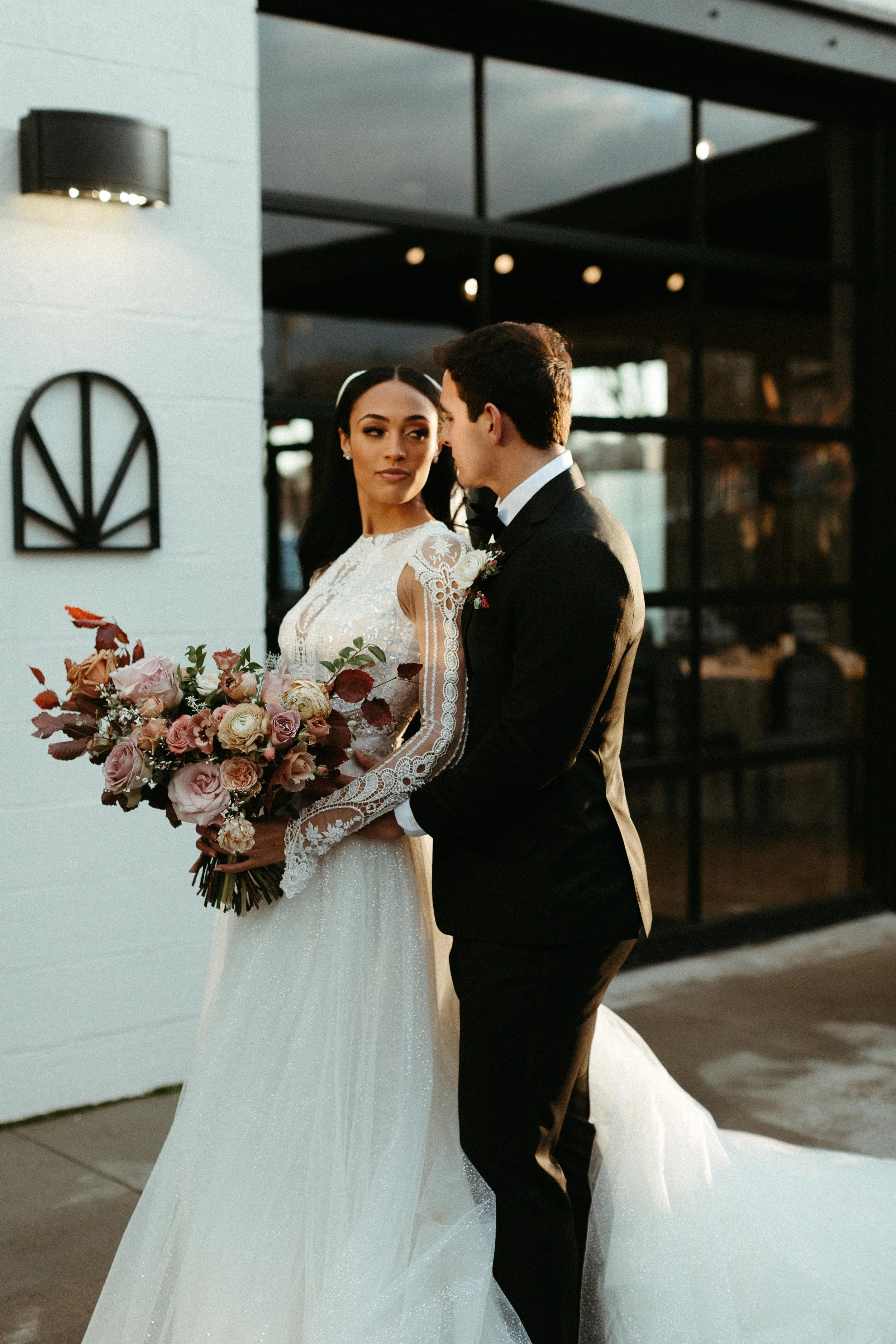 This elegant bridal bouquet brought hues of mauve, dusty pink, cream, burgundy, and terra cotta to this winter wedding. Lush with petal heavy roses, ranunculus, spray roses, copper beech, and greenery. Designed by Rosemary and Finch in Nashville, TN.